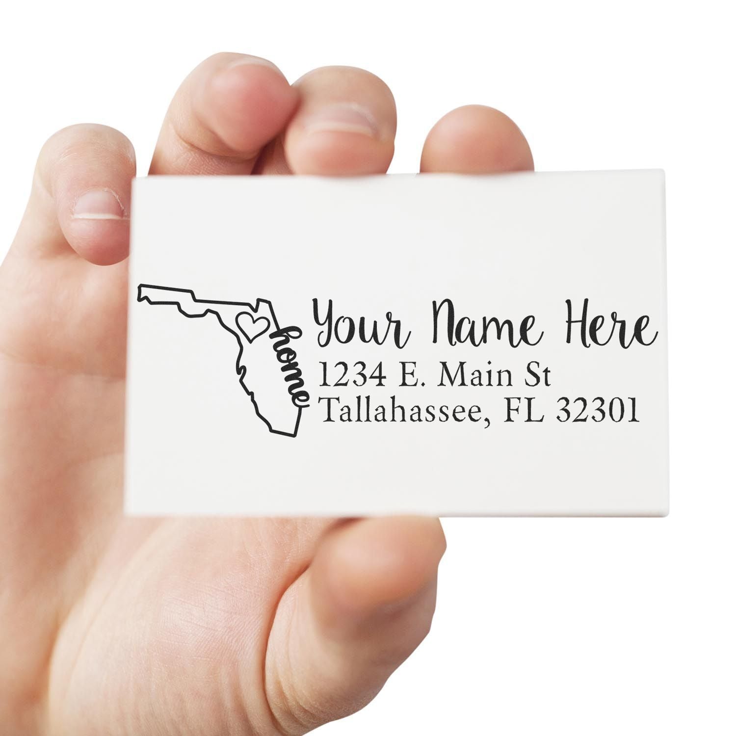 Personalized Florida return address rubber stamp with name and Tallahassee, FL address, held in hand.