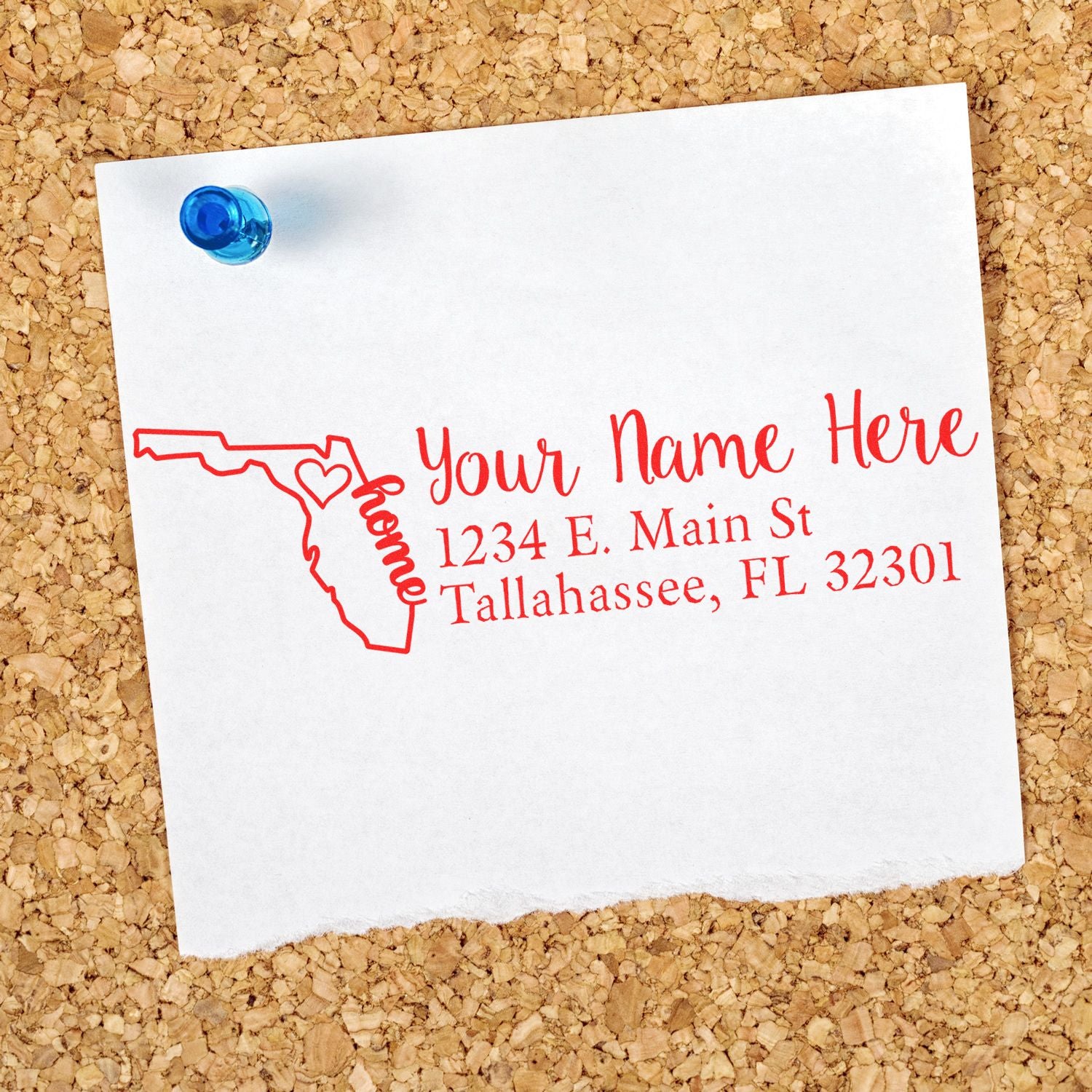 Custom Florida address rubber stamp with name and Tallahassee, FL 32301 printed on paper pinned to corkboard.
