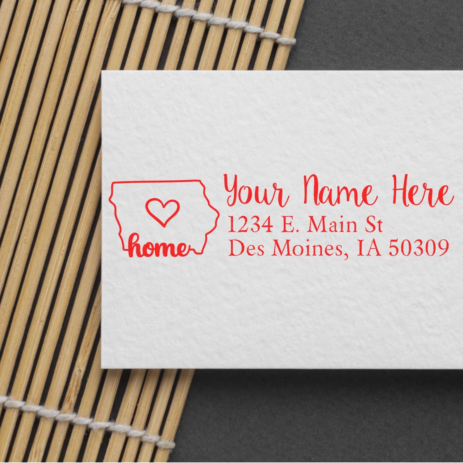 Personalized rubber address stamp with Iowa home design and custom return address on envelope.