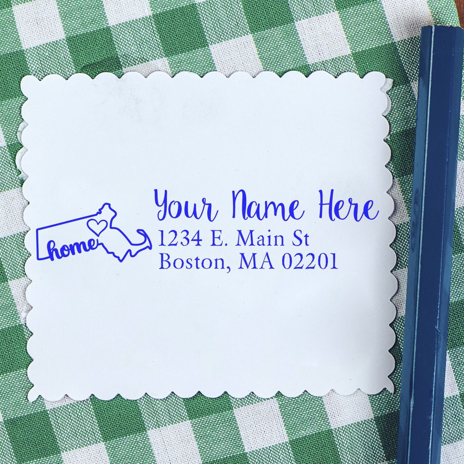 Personalized address rubber stamp with home icon and name, street address, and Boston, MA imprint on paper.