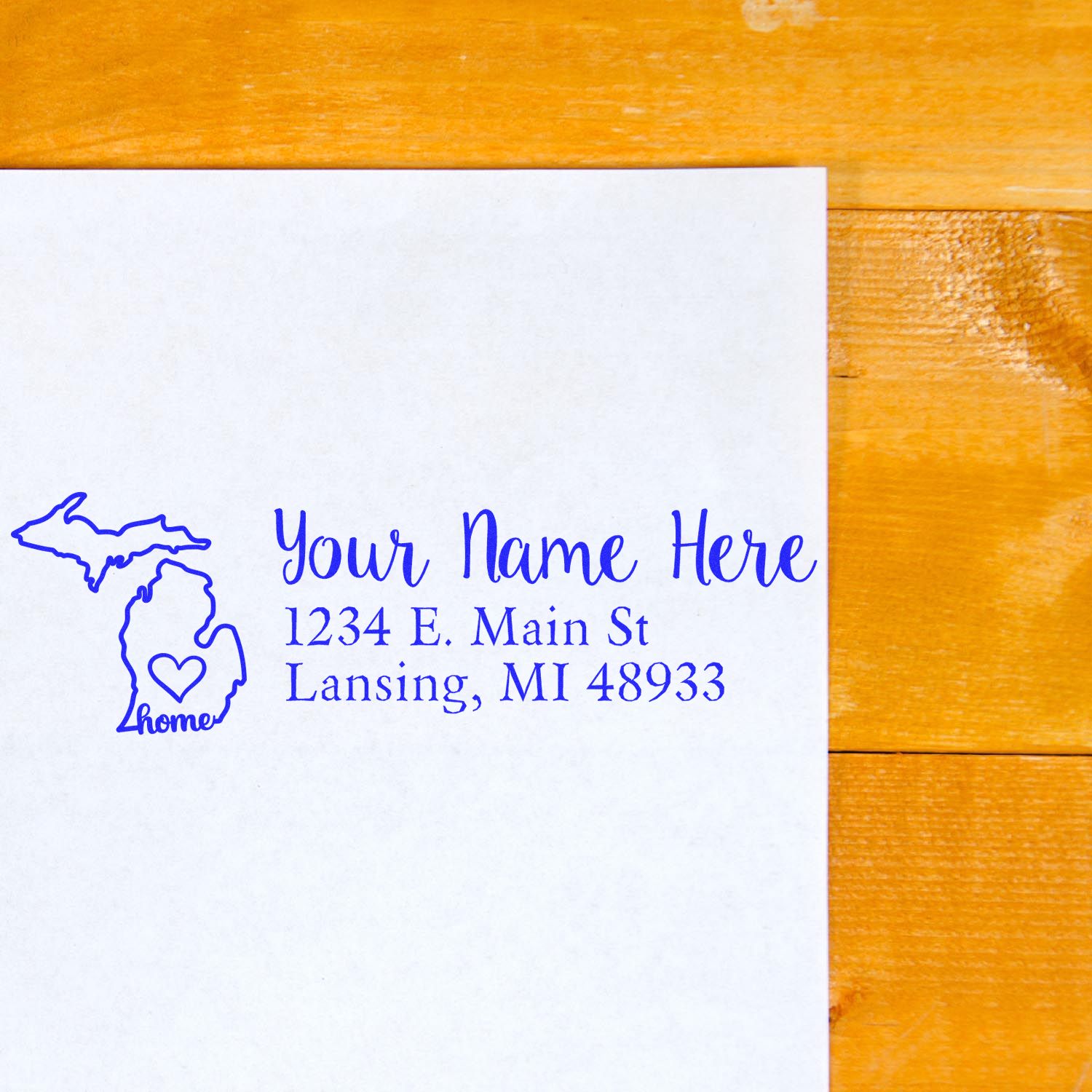 Custom address rubber stamp with Michigan home design, personalized name, and Lansing, MI return address for mailings.
