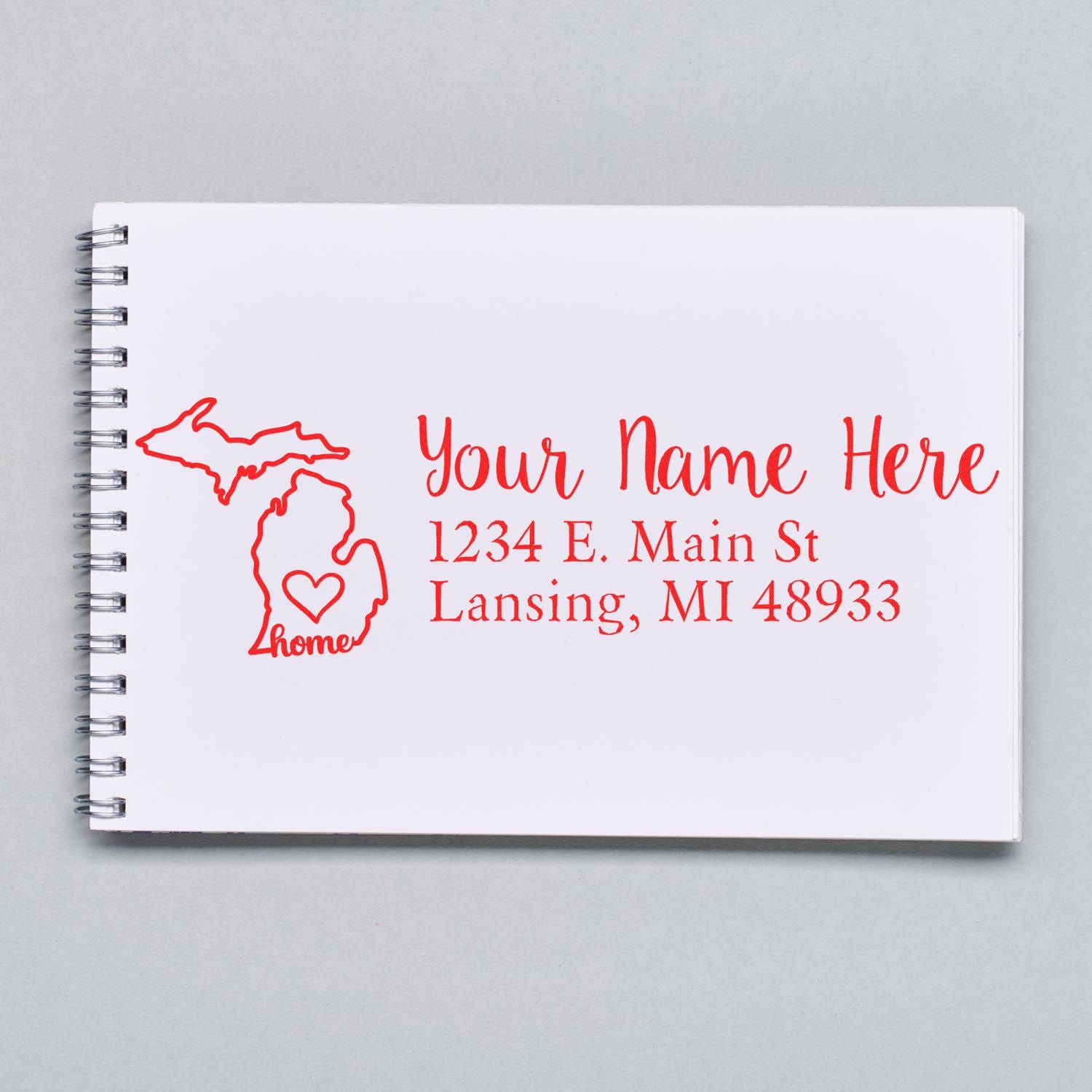 Custom Michigan home address rubber stamp with name, street, and city for personalized return addressing.