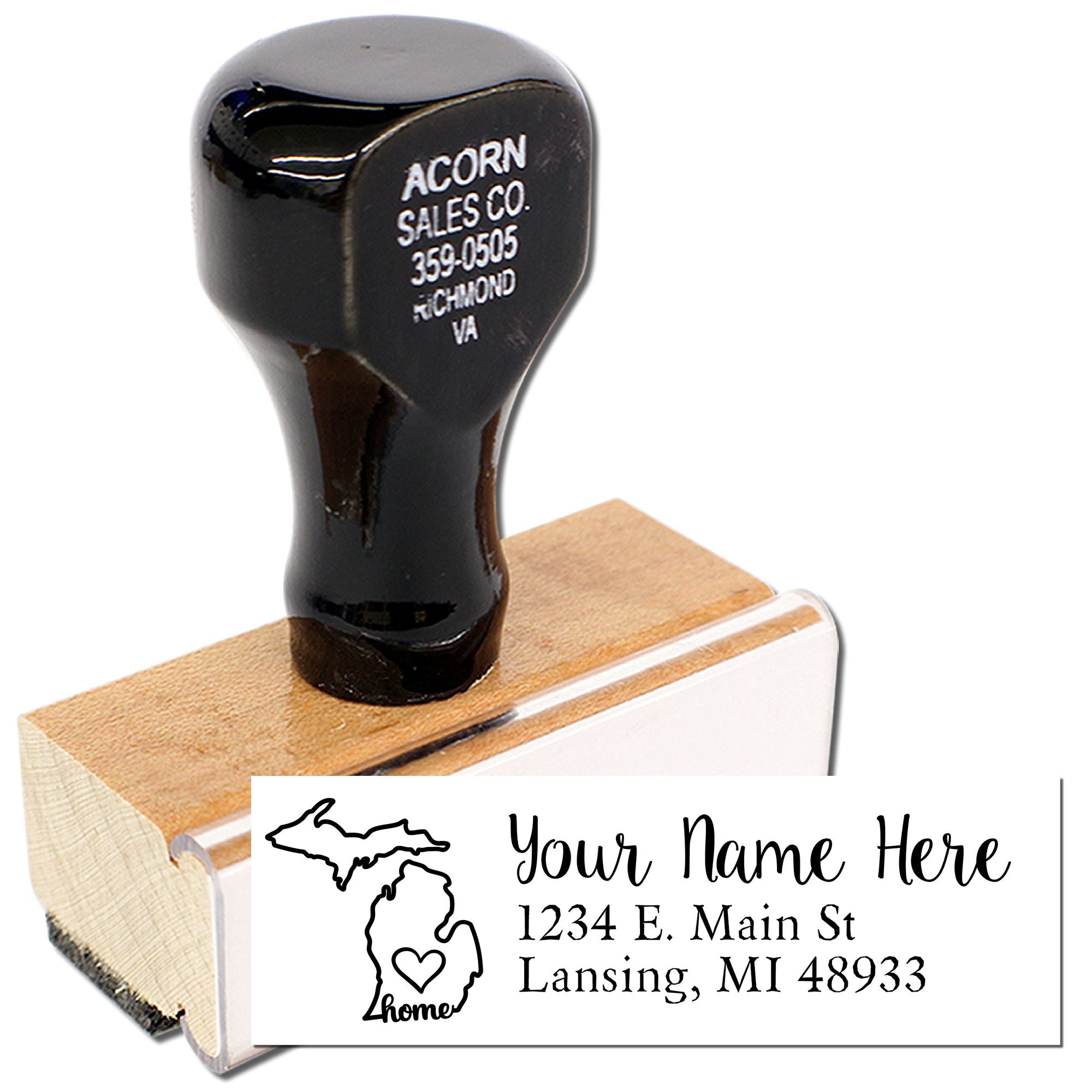 Personalized Michigan home address rubber stamp on wooden handle, showing custom name and Lansing, MI address imprint.