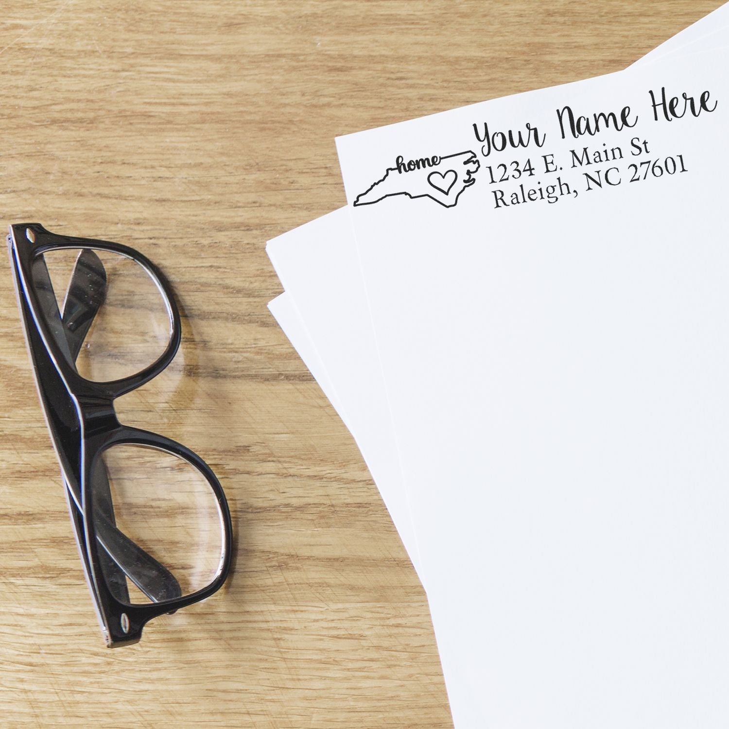 Custom rubber address stamp with North Carolina return address design on envelopes for personalized mailing.