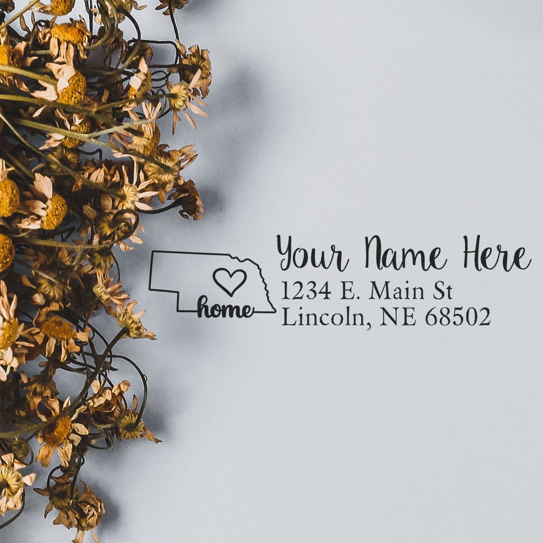 Personalized Nebraska home return address rubber stamp with heart design and custom name and address.