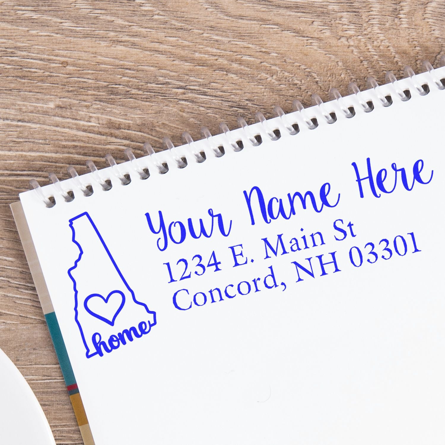 Custom return address rubber stamp with New Hampshire home design and personalized name and address.