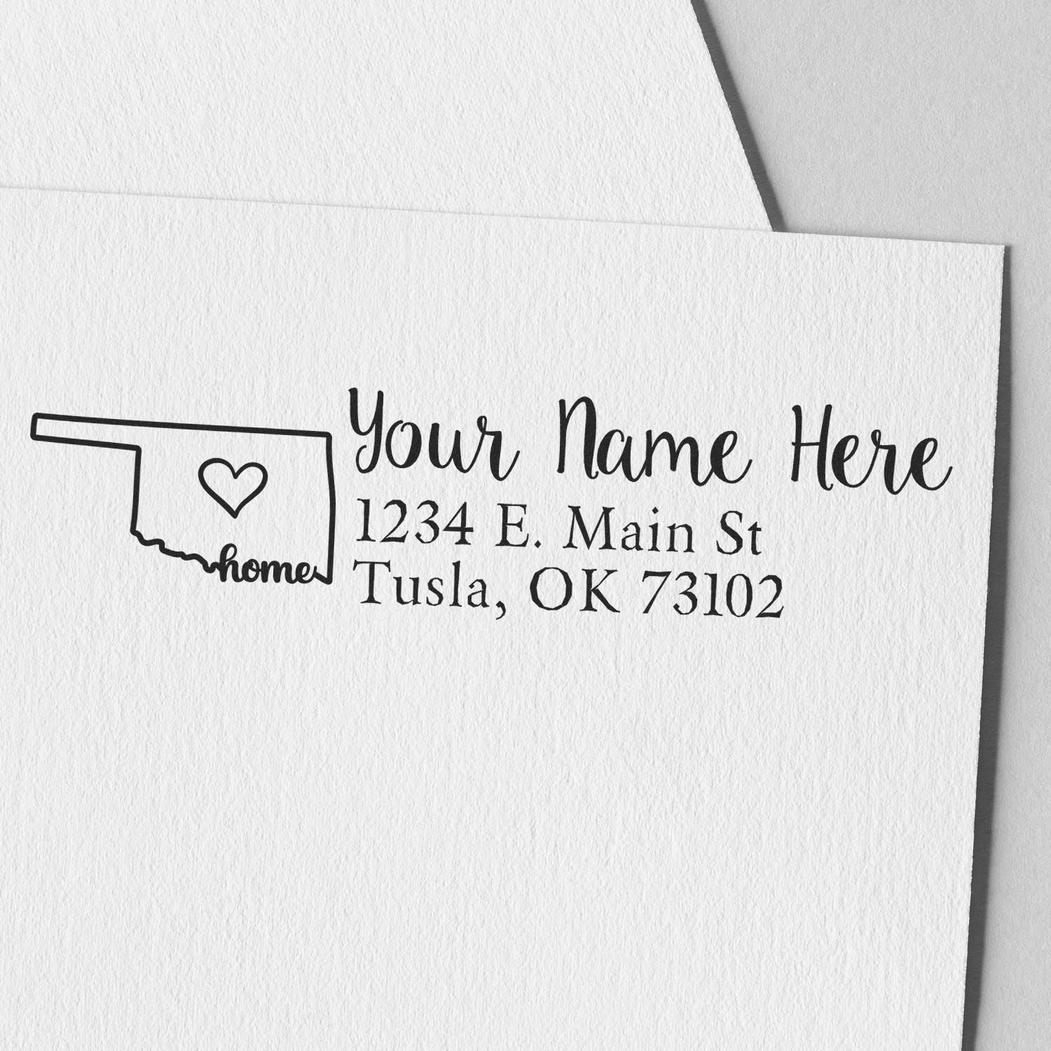 Custom rubber return address stamp with Oklahoma home outline, heart icon, and personalized name and address for stationery.