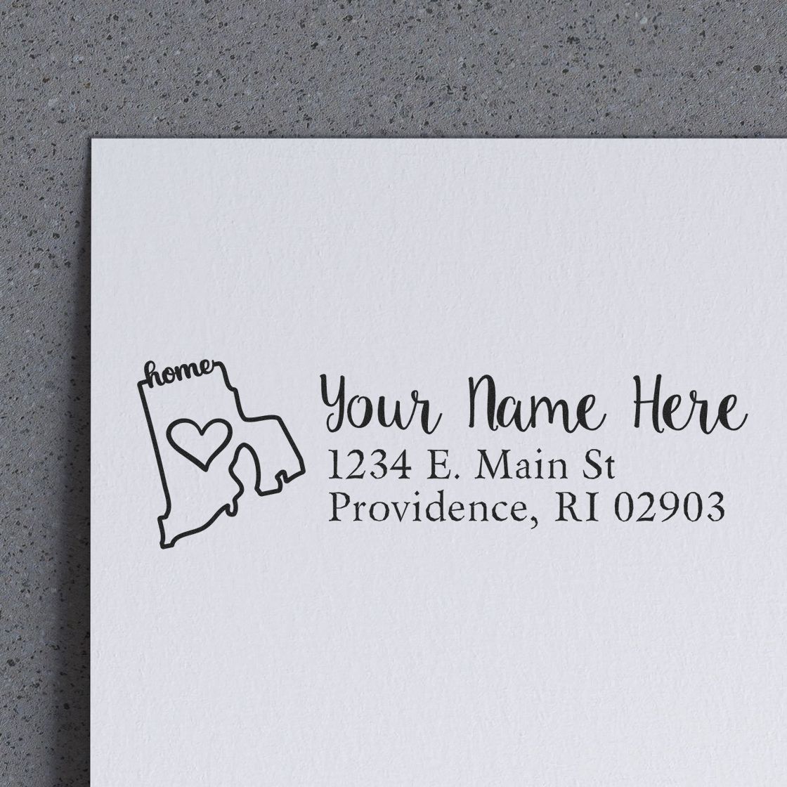Custom home address rubber stamp with Rhode Island outline and heart icon, personalized for mail, stationery, and wedding envelopes.