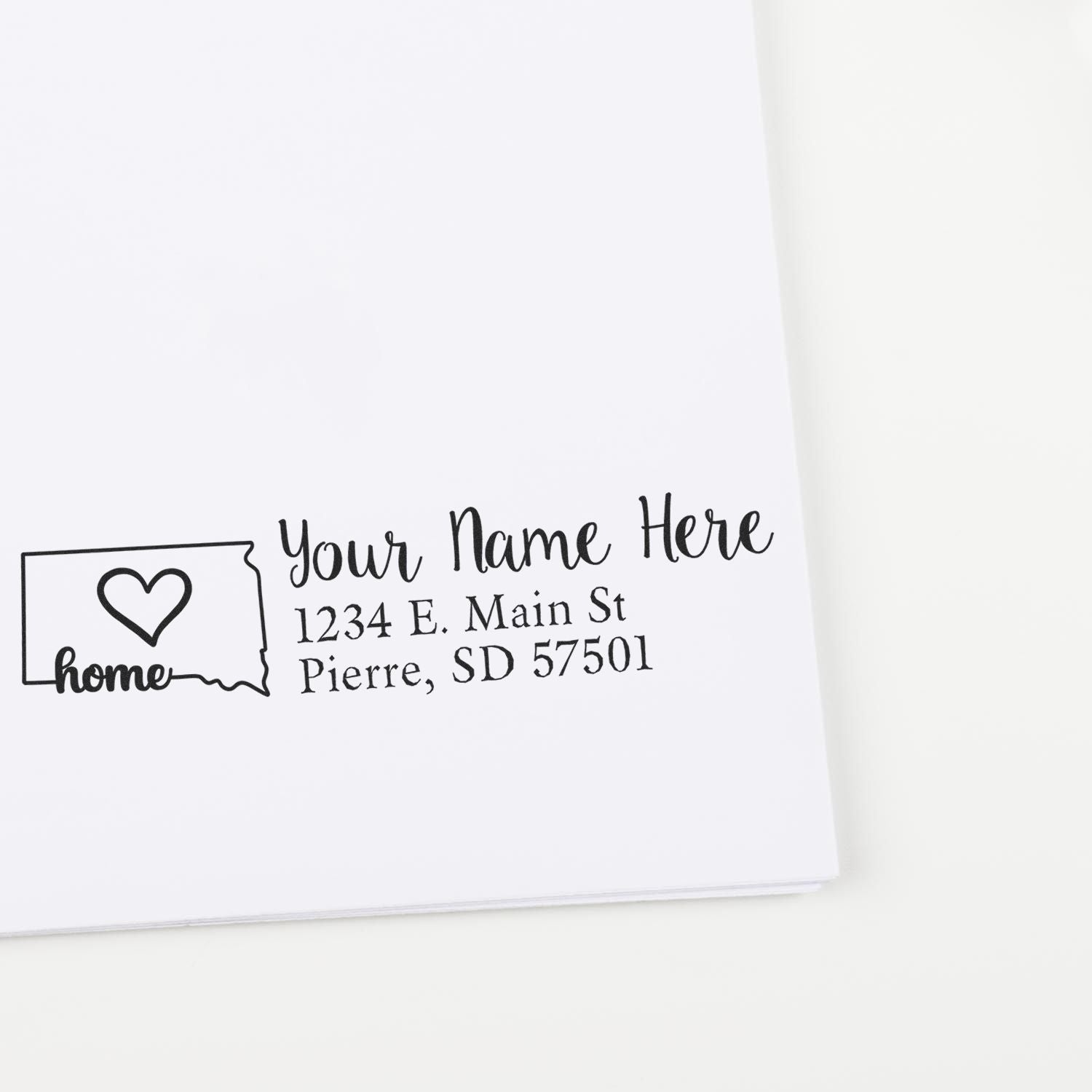 Custom home return address rubber stamp with name, address, and heart-in-house design for envelopes and stationery.