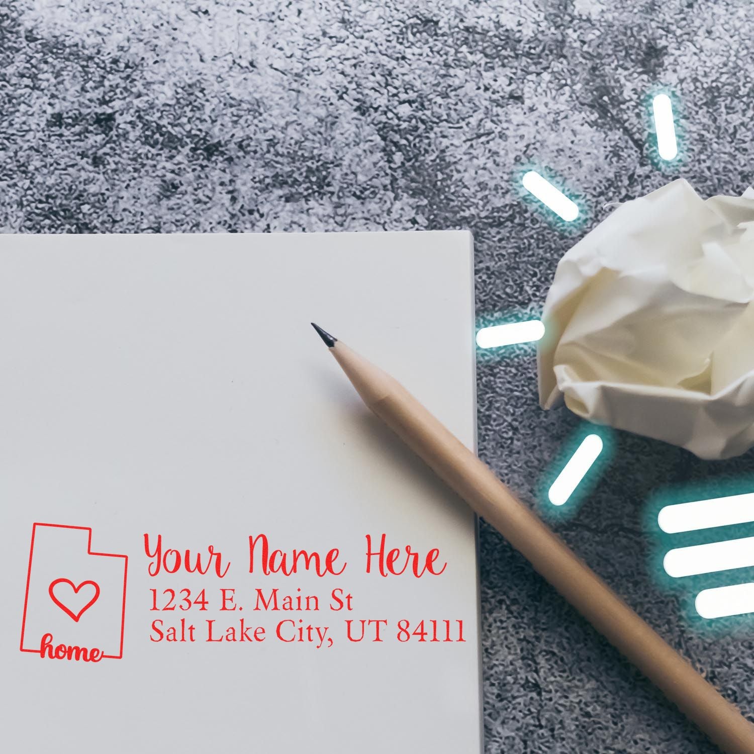 Custom rubber stamp design with name and address on a blank envelope, featuring a home icon, pencil, and crumpled paper.