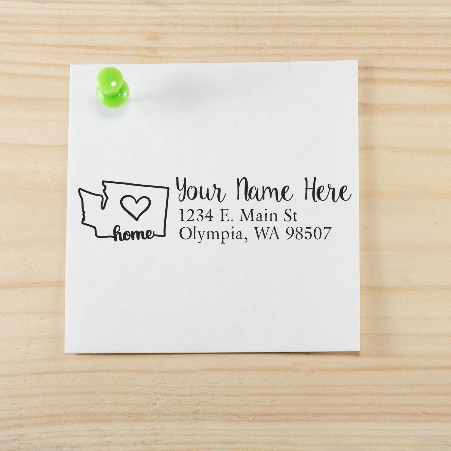 Personalized rubber stamp return address design with Washington home icon, name, and address on white paper.