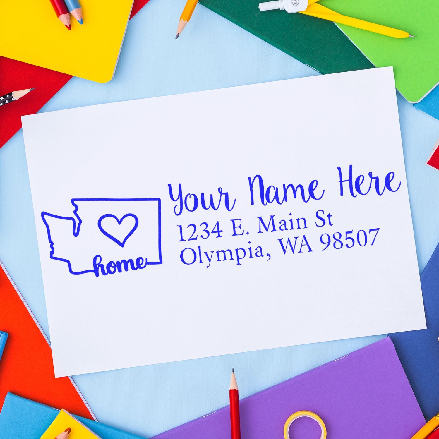 Custom rubber address stamp with home state design and sample return address on stationery.