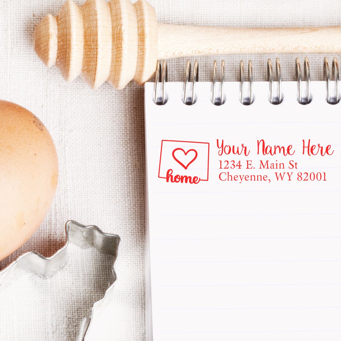 Custom home address rubber stamp imprint with heart and house icon on notepad, for personalized mailing and return labeling.