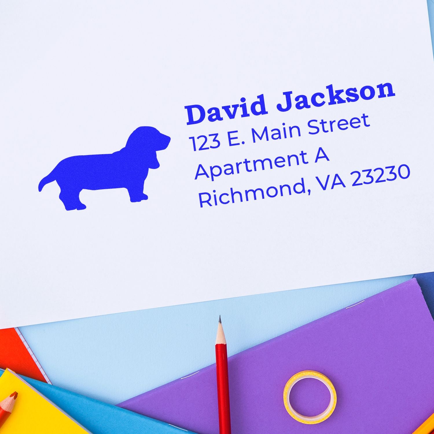 Custom rubber return address stamp with dog silhouette for personalized mailing labels and envelopes.