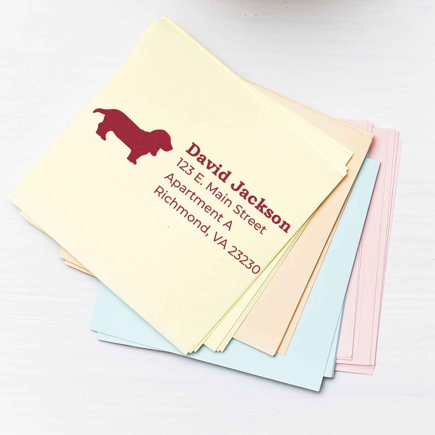 Custom return address rubber stamp for envelopes, featuring a dog silhouette and personalized mailing address.