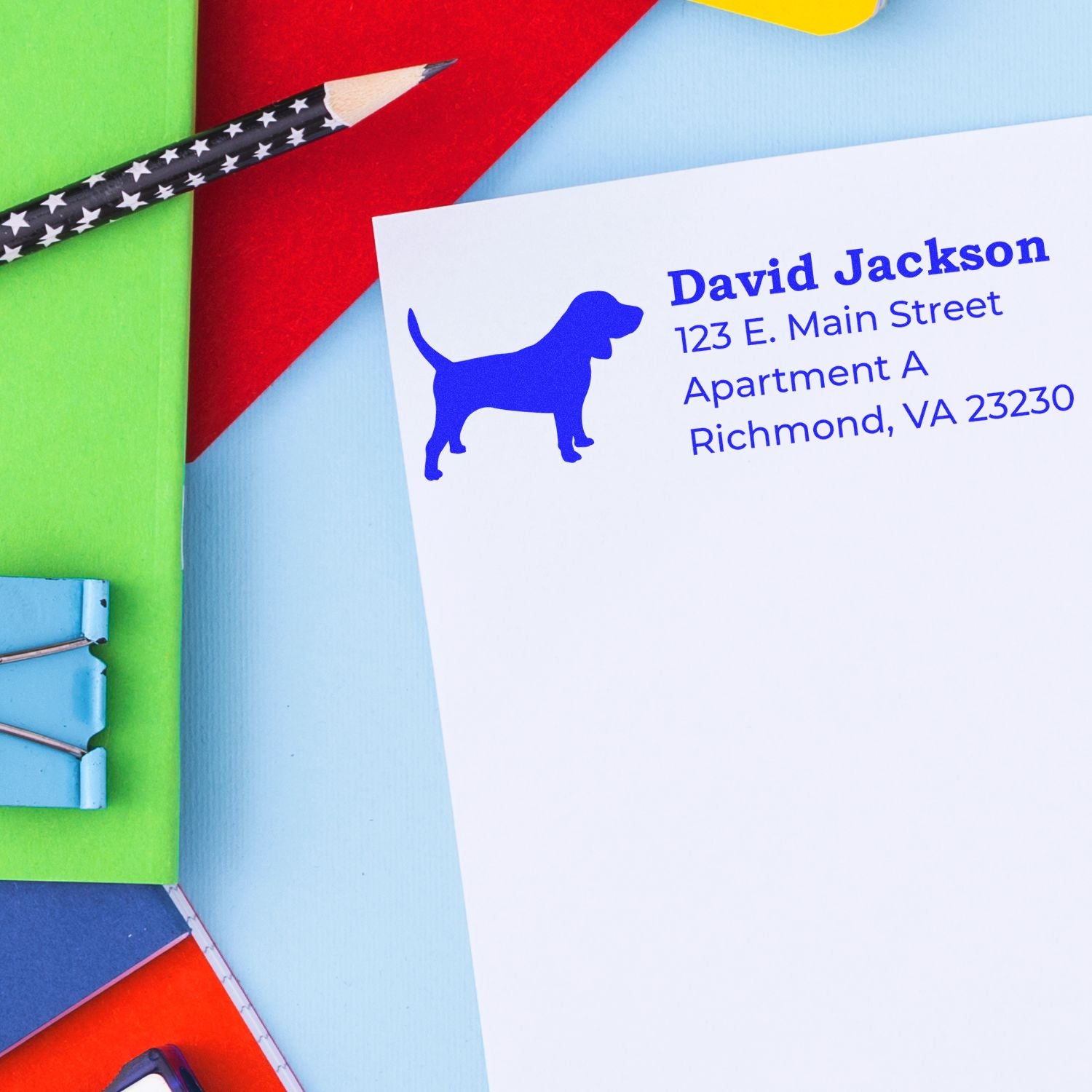 Personalized dog return address rubber stamp on envelope, showing blue pet silhouette and custom mailing address.