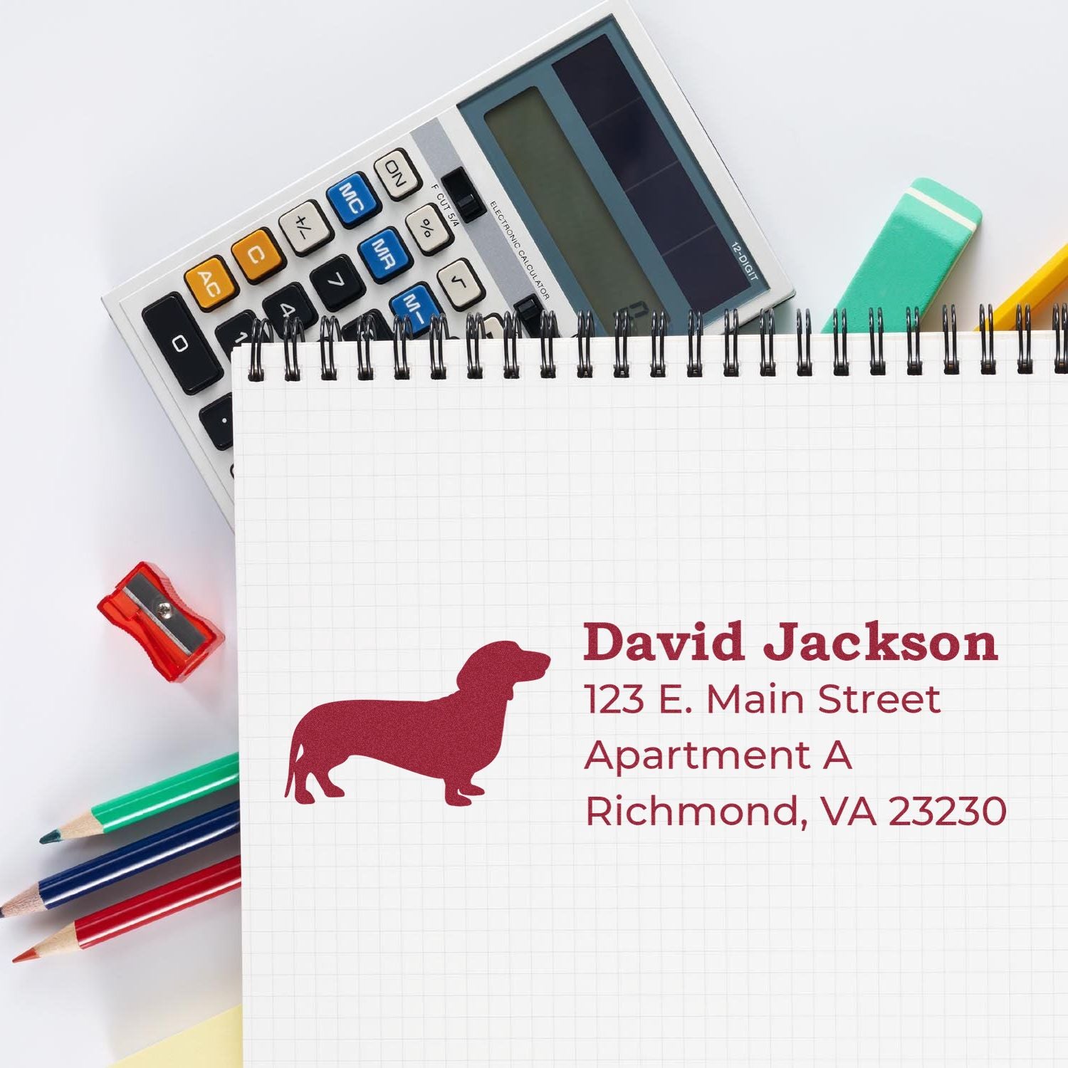 Custom rubber address stamp with dog silhouette, showing personalized name and address imprint for pet-themed mailing.