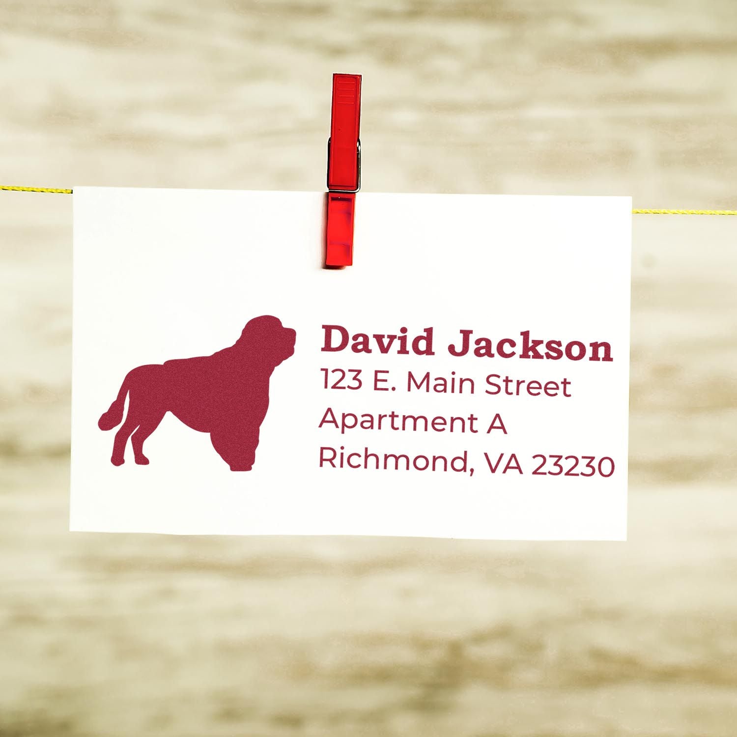 Personalized return address rubber stamp design with dog silhouette, name, and mailing address on a clipped card.