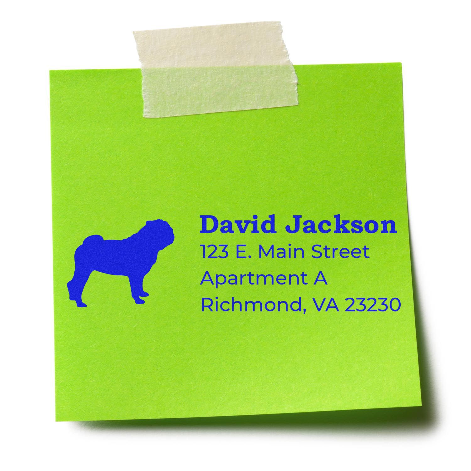 Custom pet return address rubber stamp with dog silhouette, name, and address on a green sticky note.