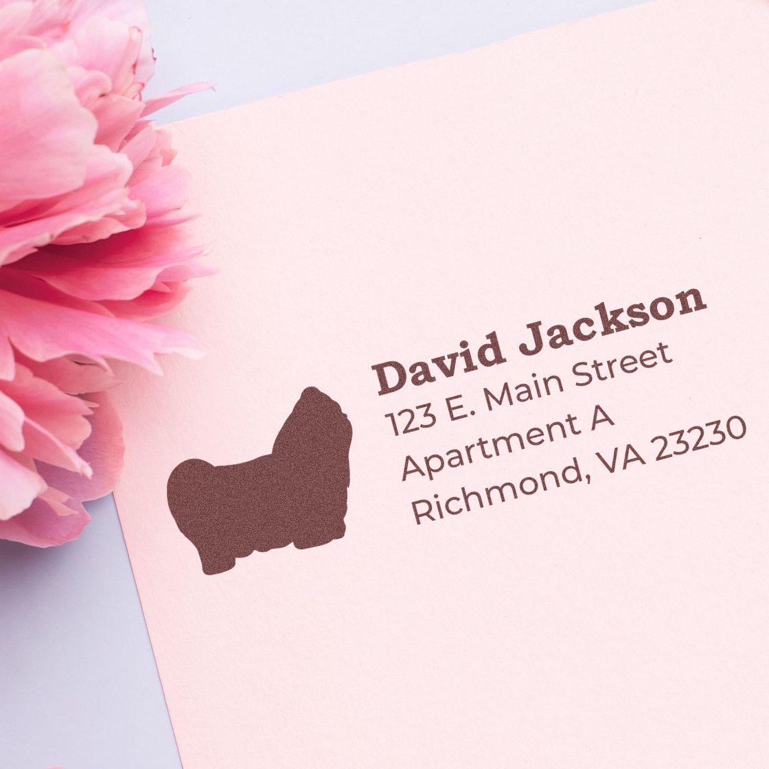 Personalized custom return address rubber stamp with dog icon on pink envelope
