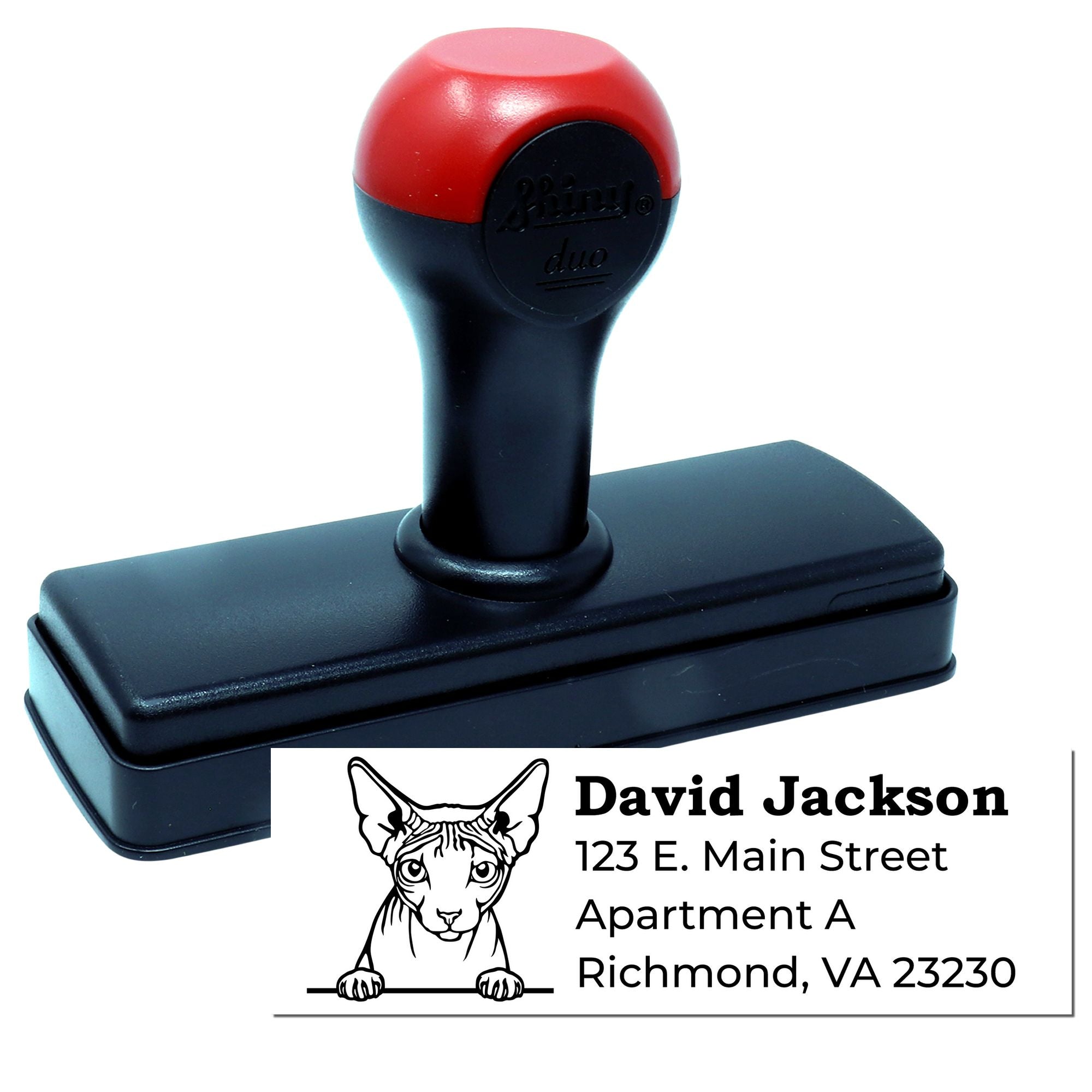 Custom self-inking rubber address stamp with cat logo and return address for personalized mailing labels.