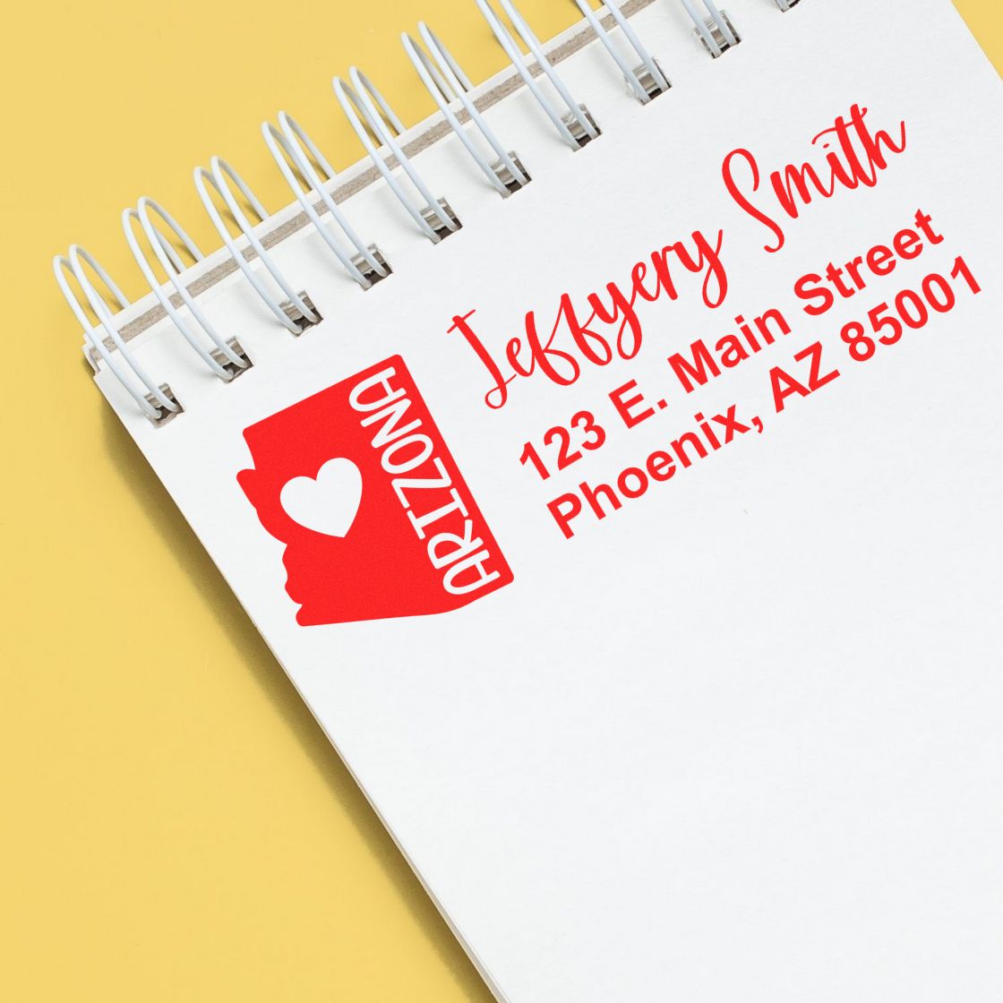 Custom Arizona rubber address stamp with name and Phoenix, AZ return address on a notebook page