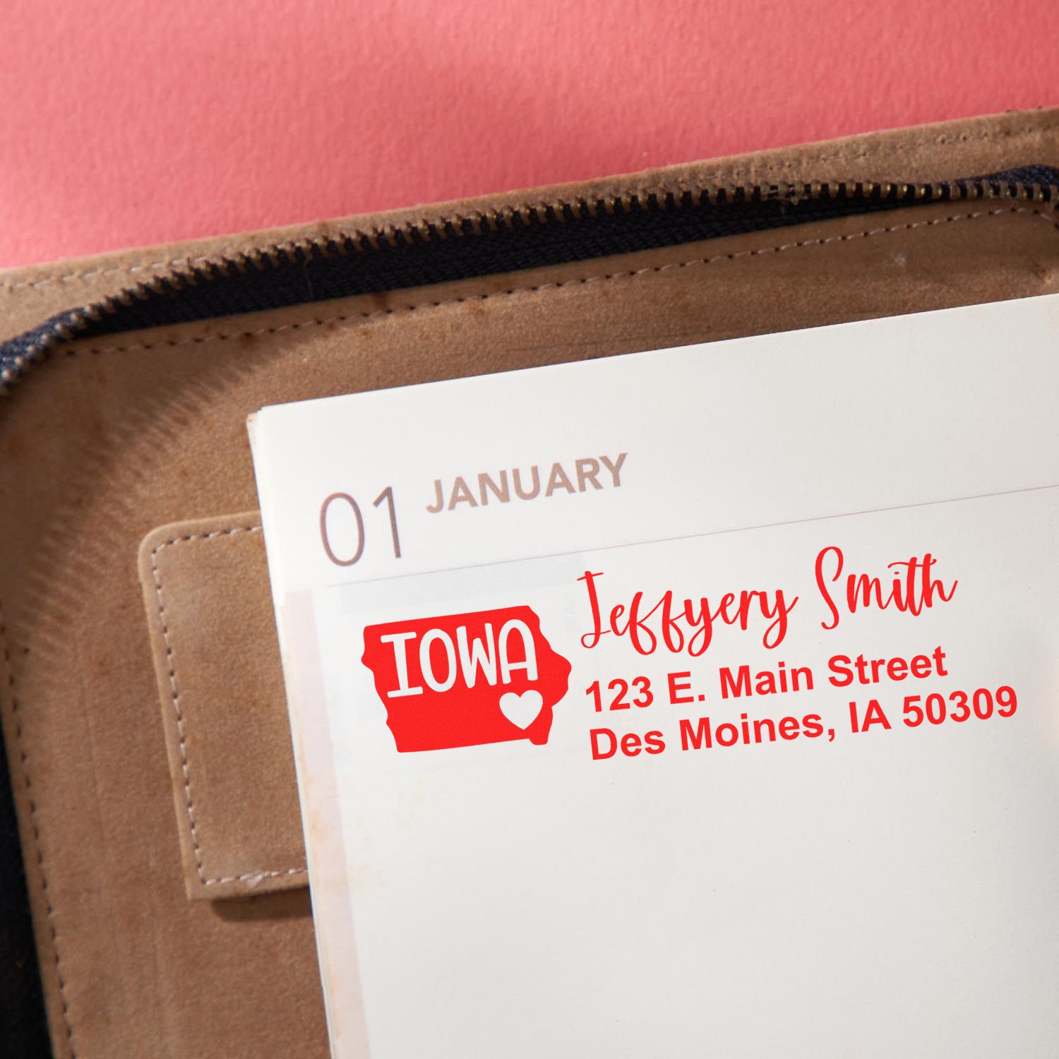 Custom address rubber stamp on envelope with Iowa state design, name, and Des Moines return address for mailing.