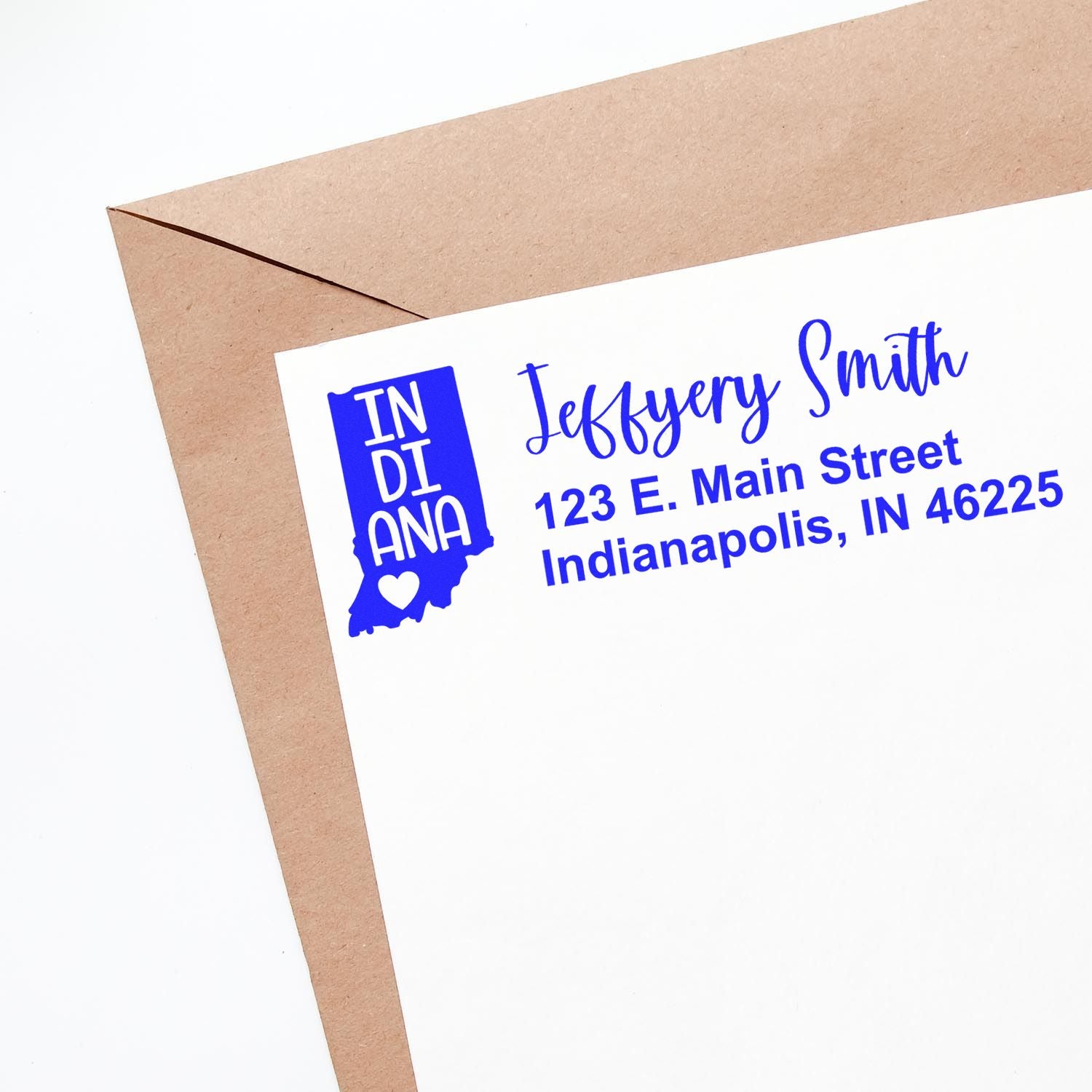 Custom Indiana return address rubber stamp on a white envelope with personalized name and address in blue ink.