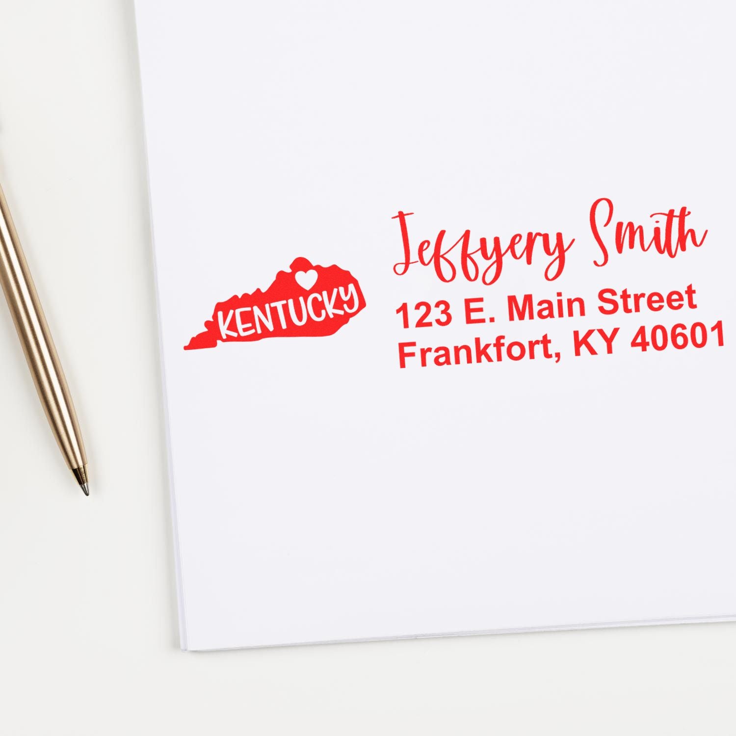 Custom Kentucky return address rubber stamp with name and Frankfort, KY address on stationery.