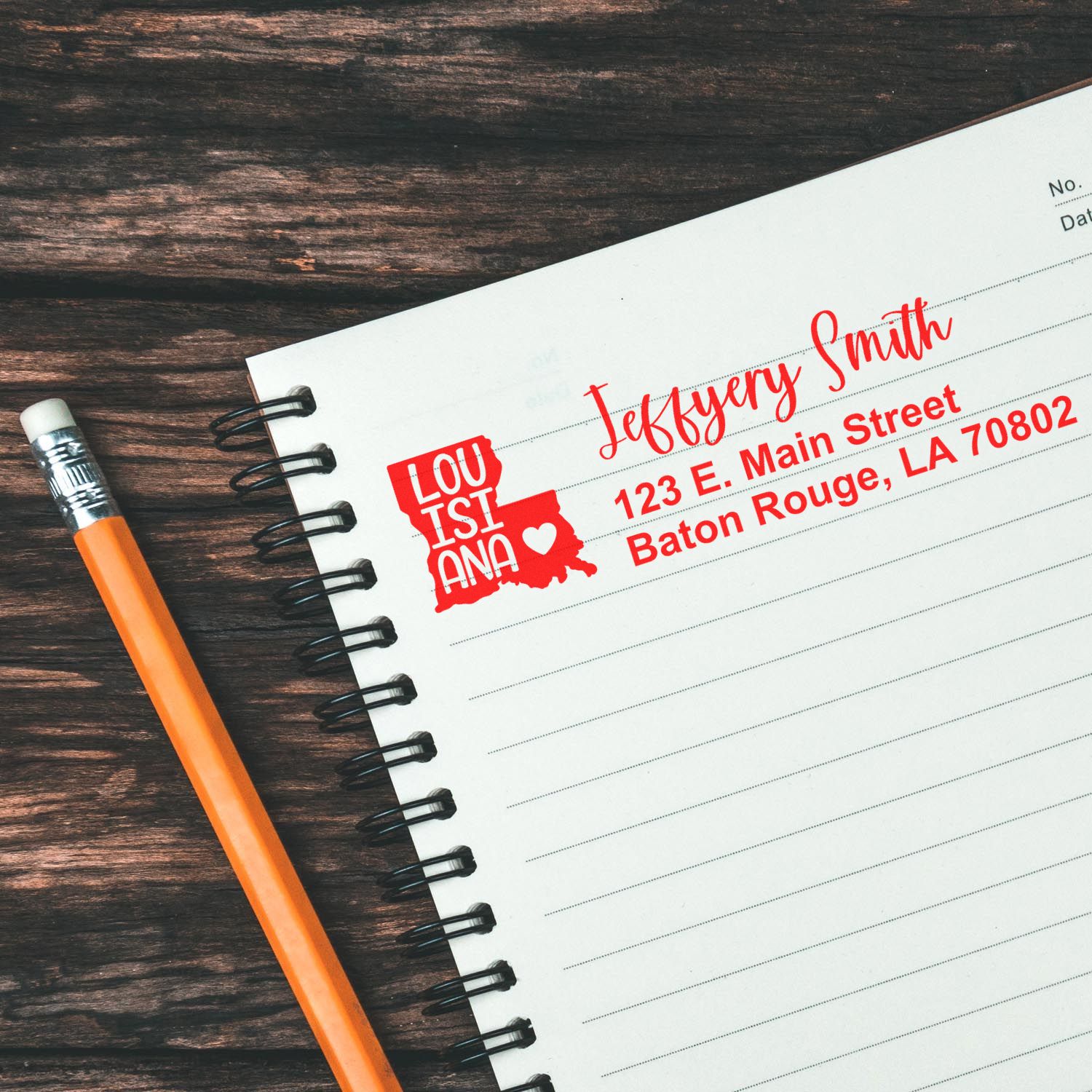 Custom Louisiana return address rubber stamp on notebook paper with name and Baton Rouge address.