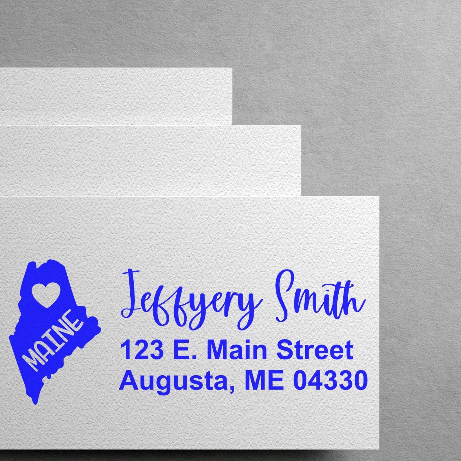 Custom Maine return address rubber stamp with name and Augusta, ME mailing address for personalized stationery.