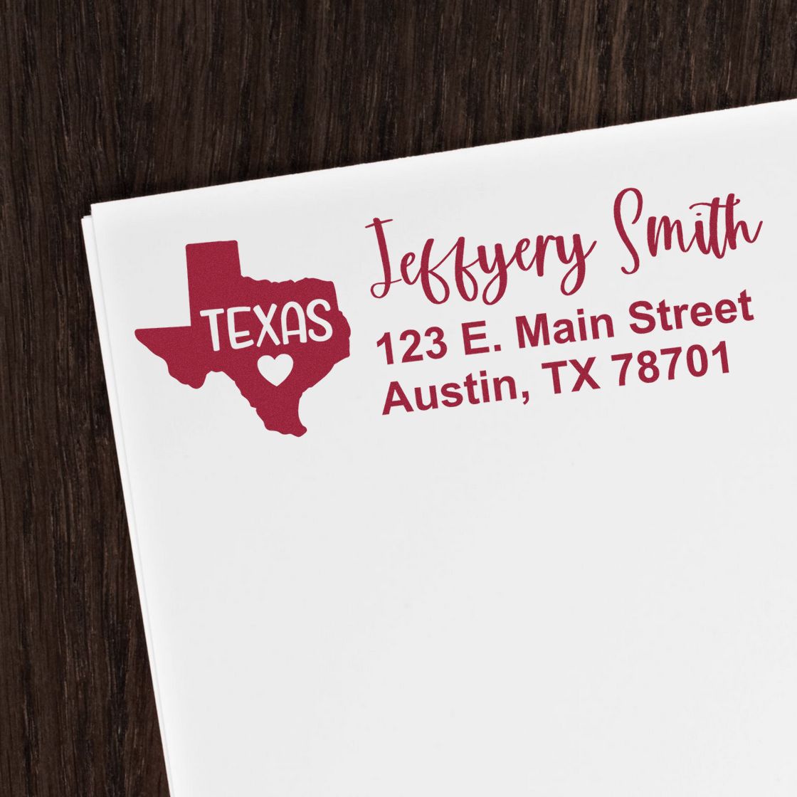 Custom Texas return address rubber stamp on white envelope with name, street address, and Austin, TX 78701.