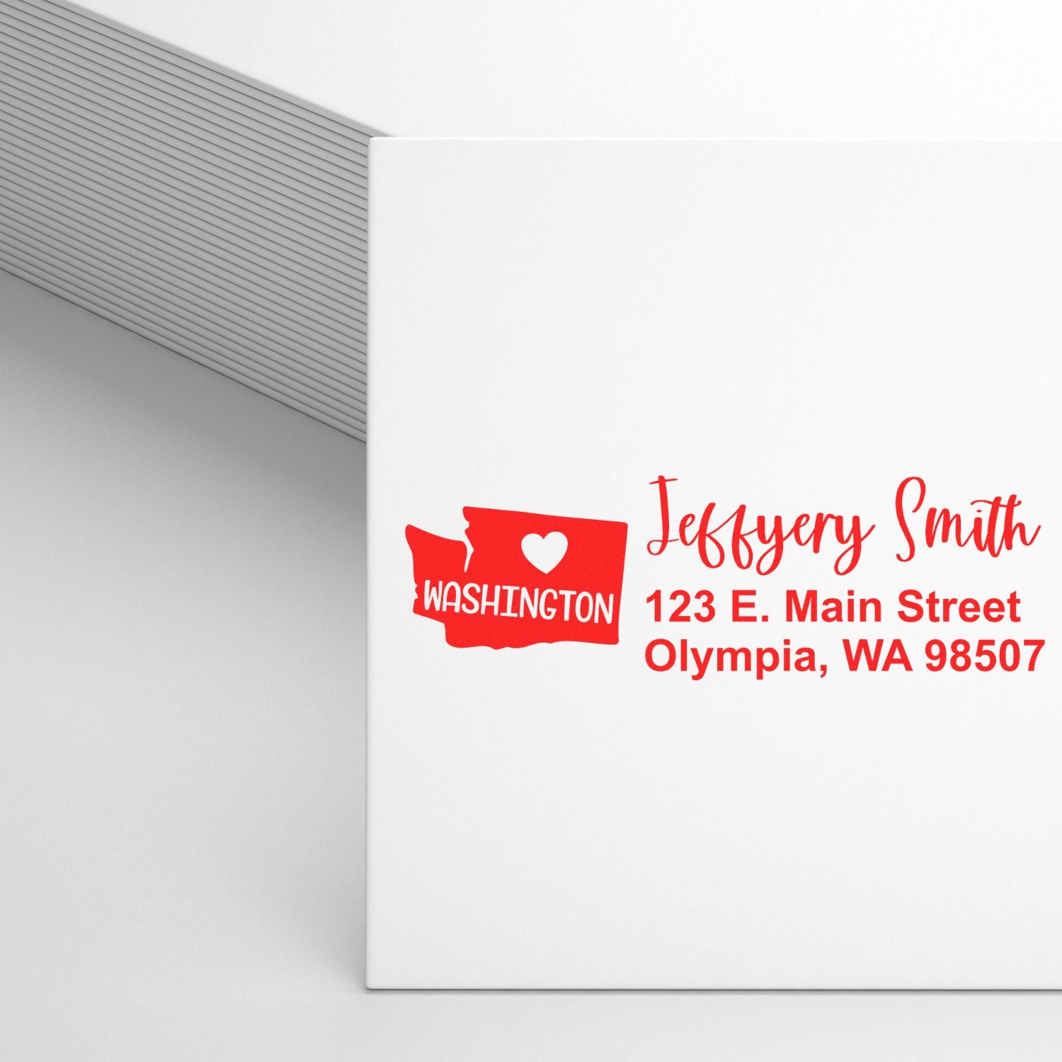 Custom return address rubber stamp on envelope with Washington state design for Jeffrey Smith, Olympia, WA.