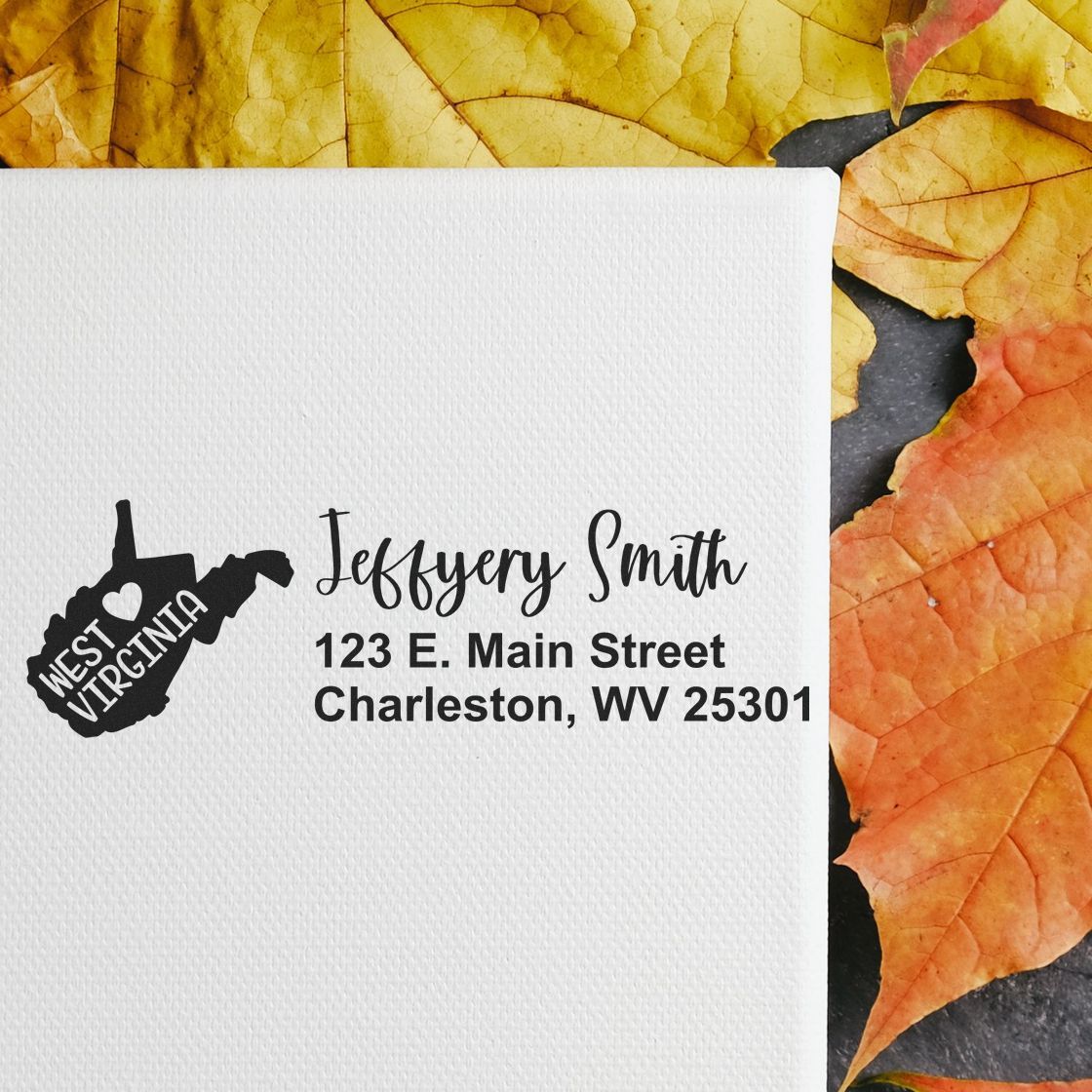 Custom West Virginia return address rubber stamp with name and Charleston, WV address on white paper