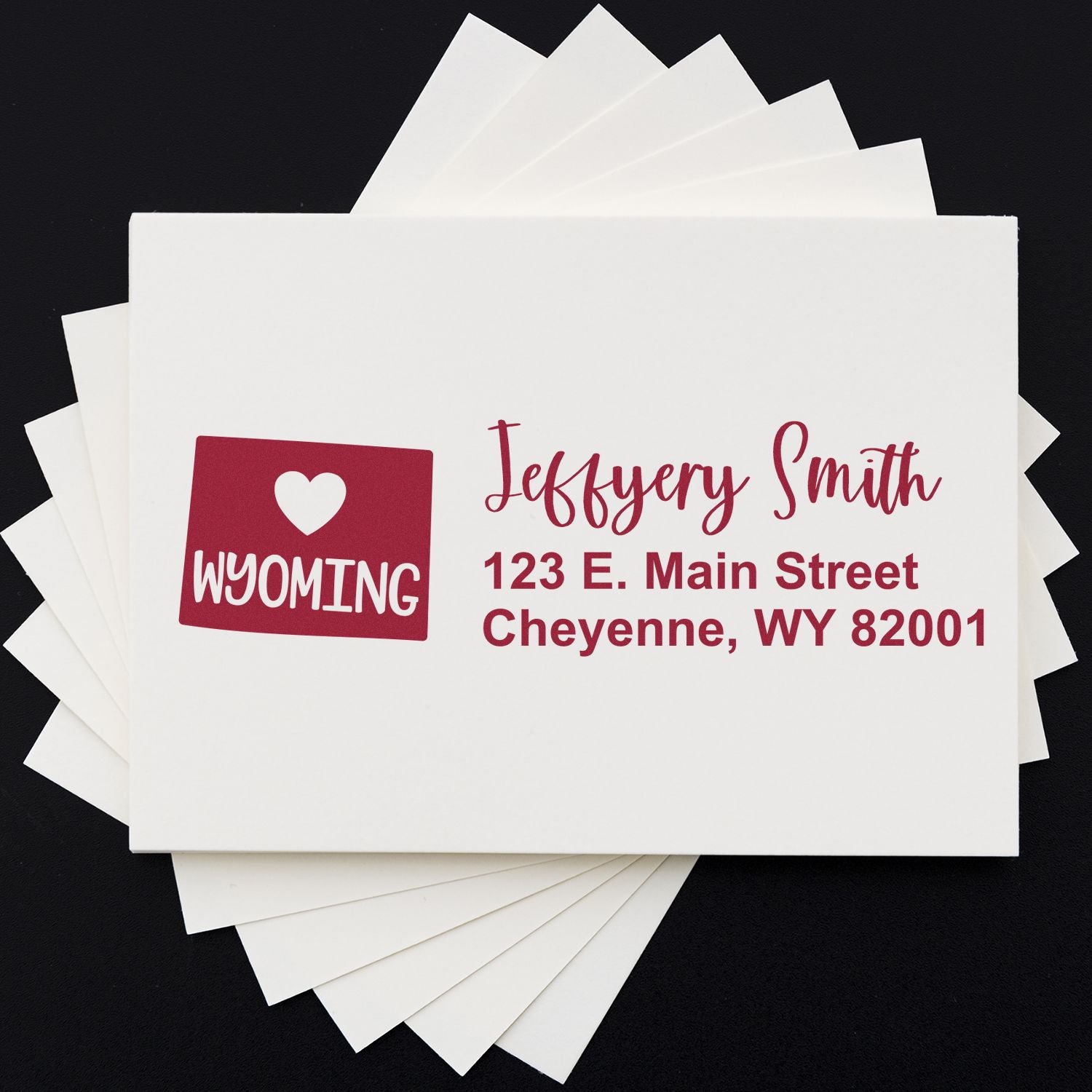 Custom rubber stamp with Wyoming logo, name, and return address for personalized mailing and branding.