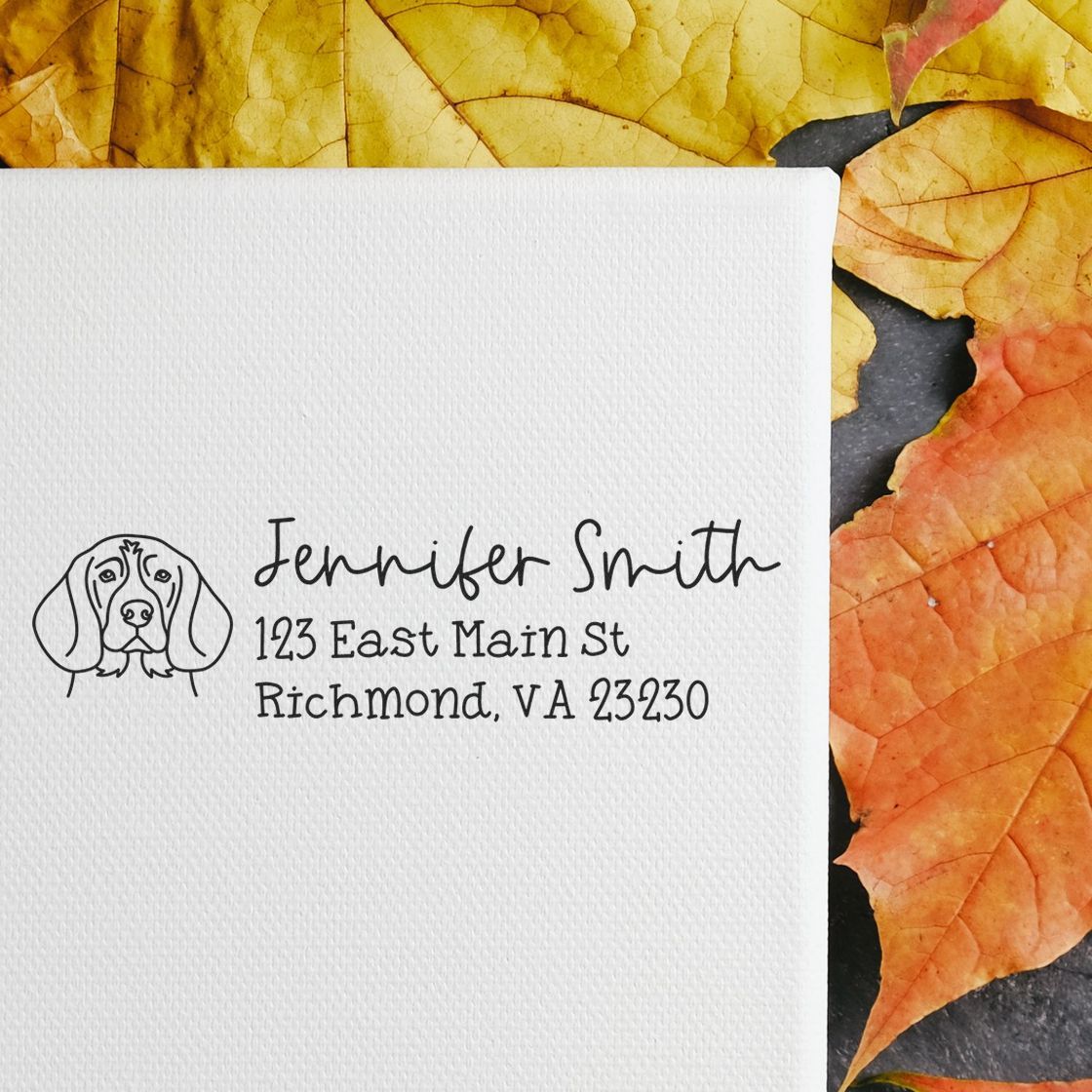 Custom dog address rubber stamp on white paper, featuring name and mailing address for personalized envelopes.