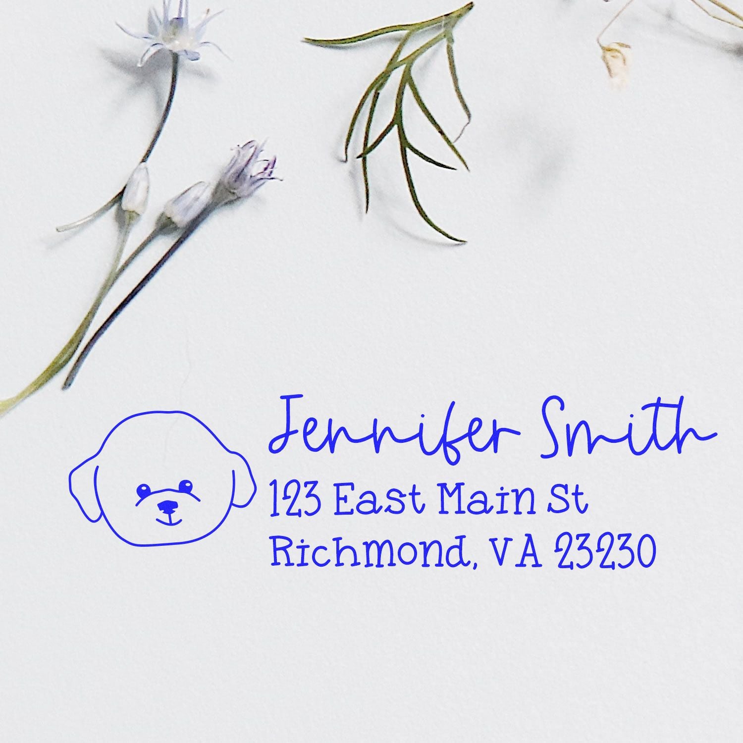 Custom blue rubber address stamp with dog logo for Jennifer Smith, 123 East Main St, Richmond, VA 23230.