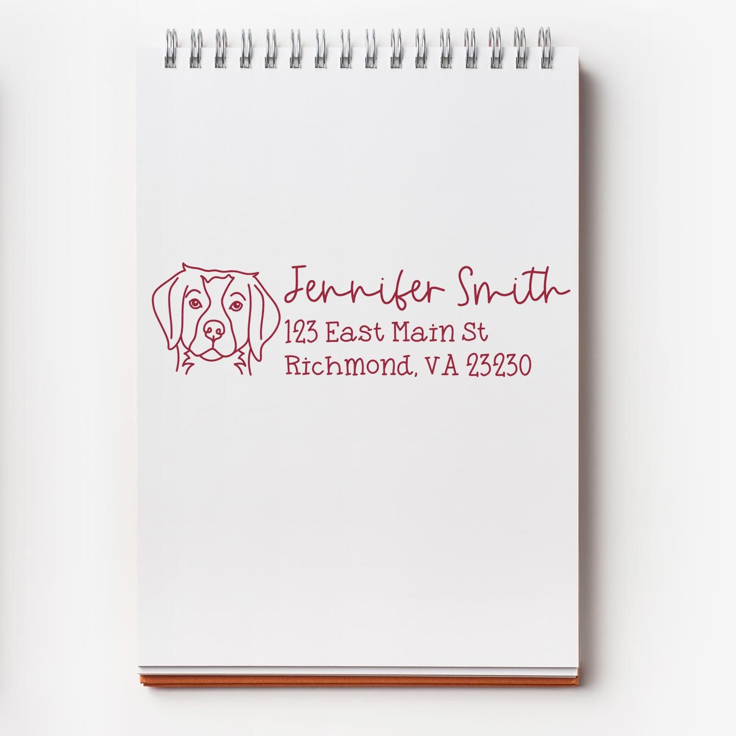 Personalized dog return address rubber stamp with Jennifer Smith name and Richmond, VA address on a notebook.