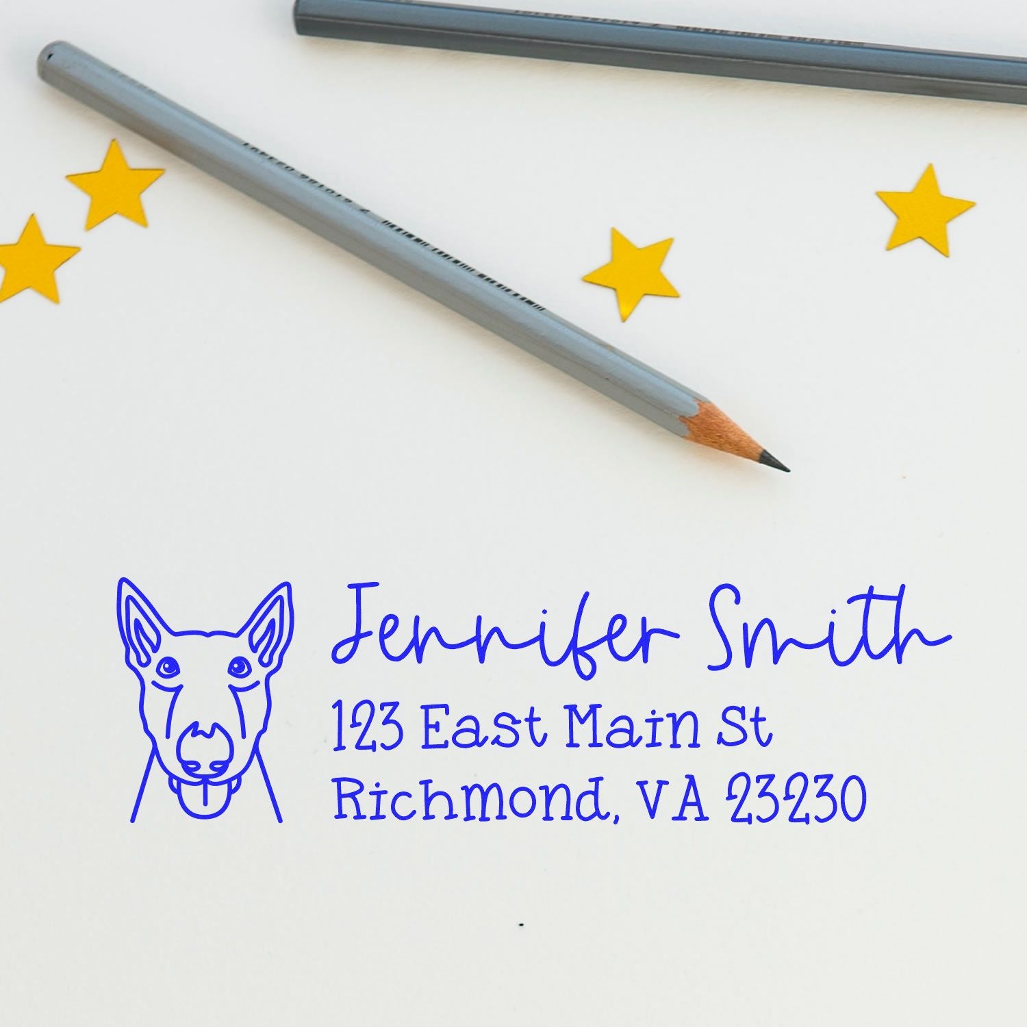 Custom dog address rubber stamp with personalized name and return address, shown with blue ink impression and pencil.