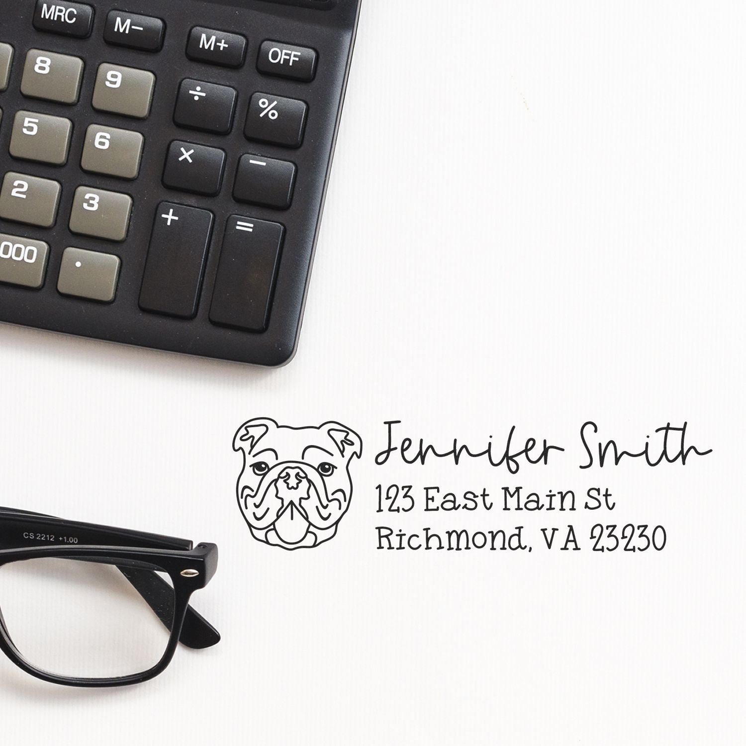 Personalized bulldog address rubber stamp with name and Richmond, VA address beside calculator and glasses