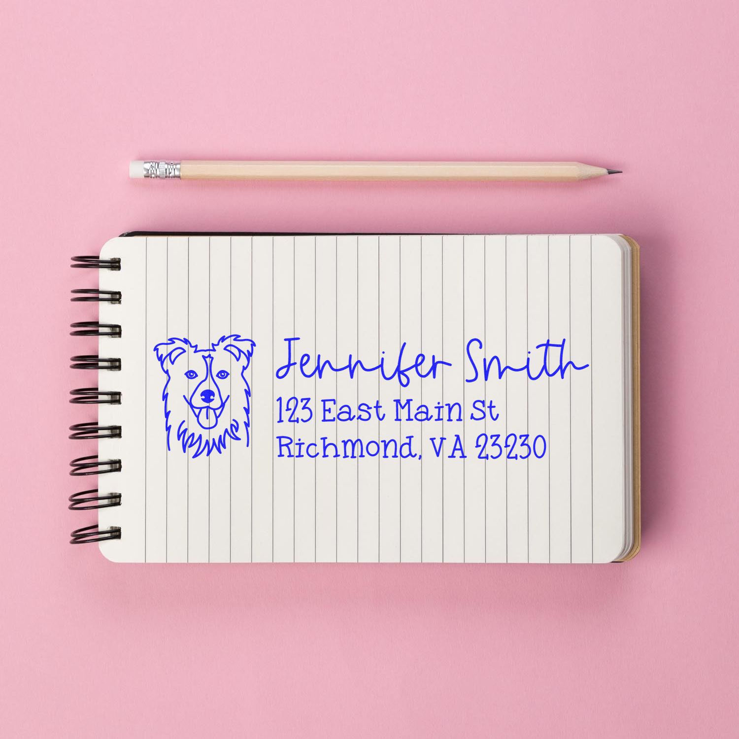 Custom dog return address rubber stamp on notebook showing name, street address, and city for personalized mailing.