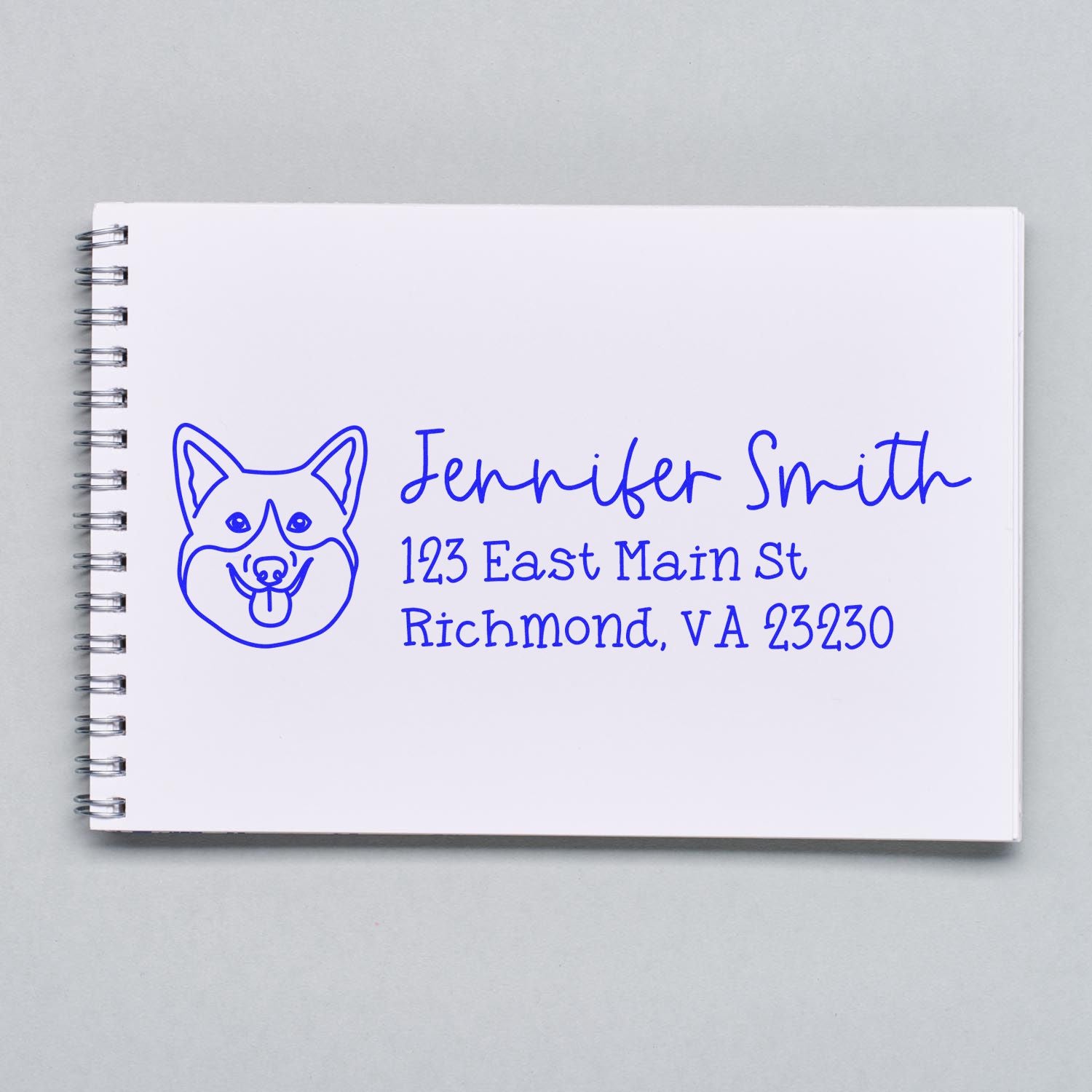 Custom dog return address rubber stamp with name and Richmond, VA address on notebook.