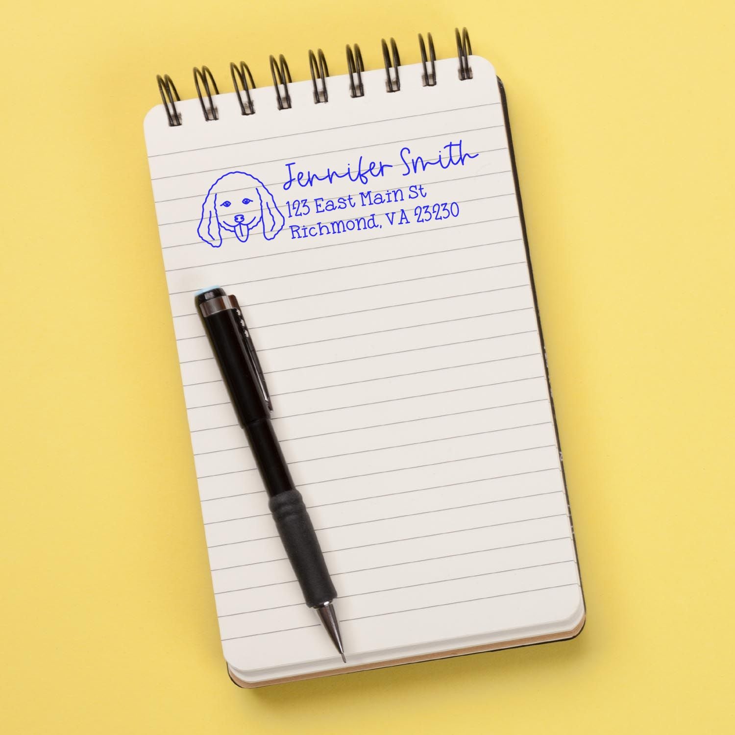 Custom dog return address rubber stamp with personalized name and Richmond, VA on notebook.