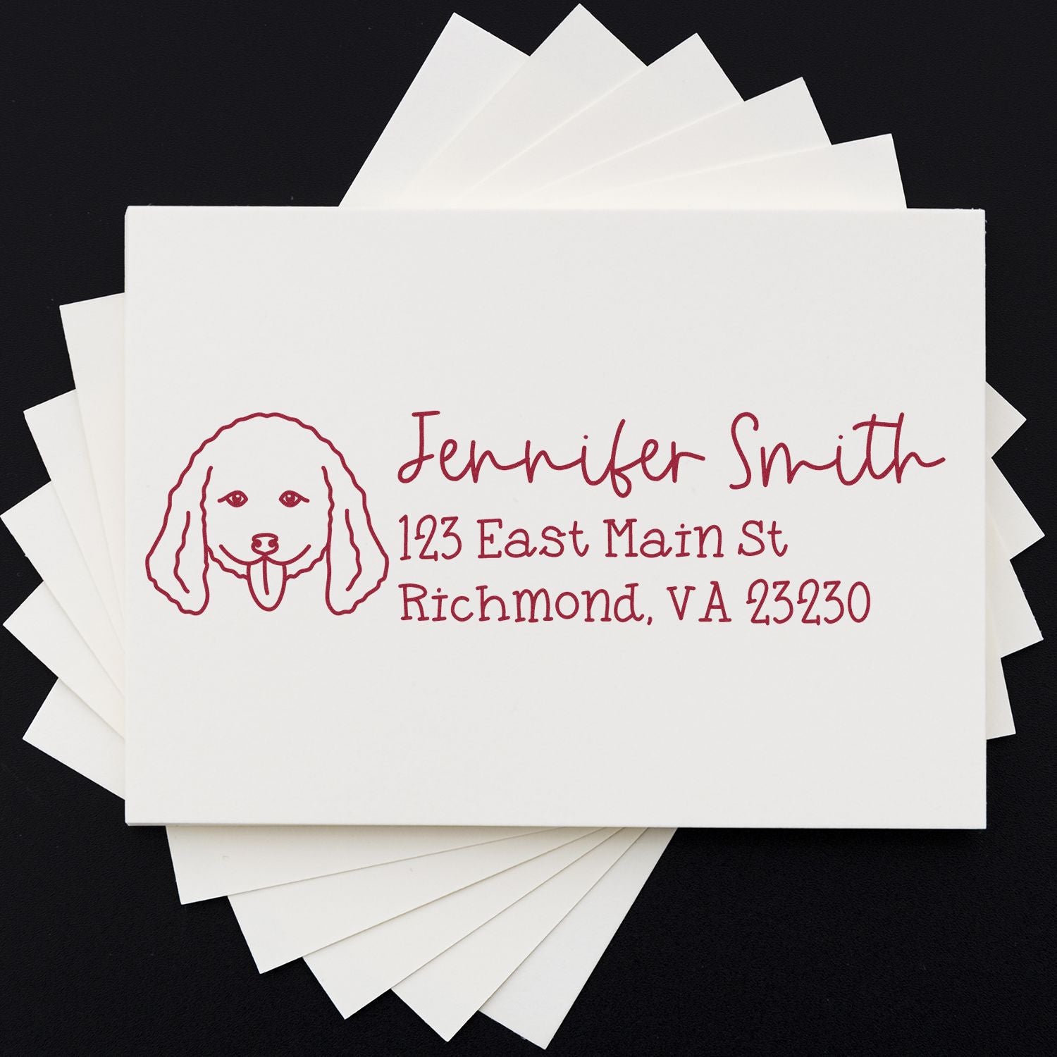 Custom return address rubber stamp with dog icon, name, and mailing address on white stationery cards