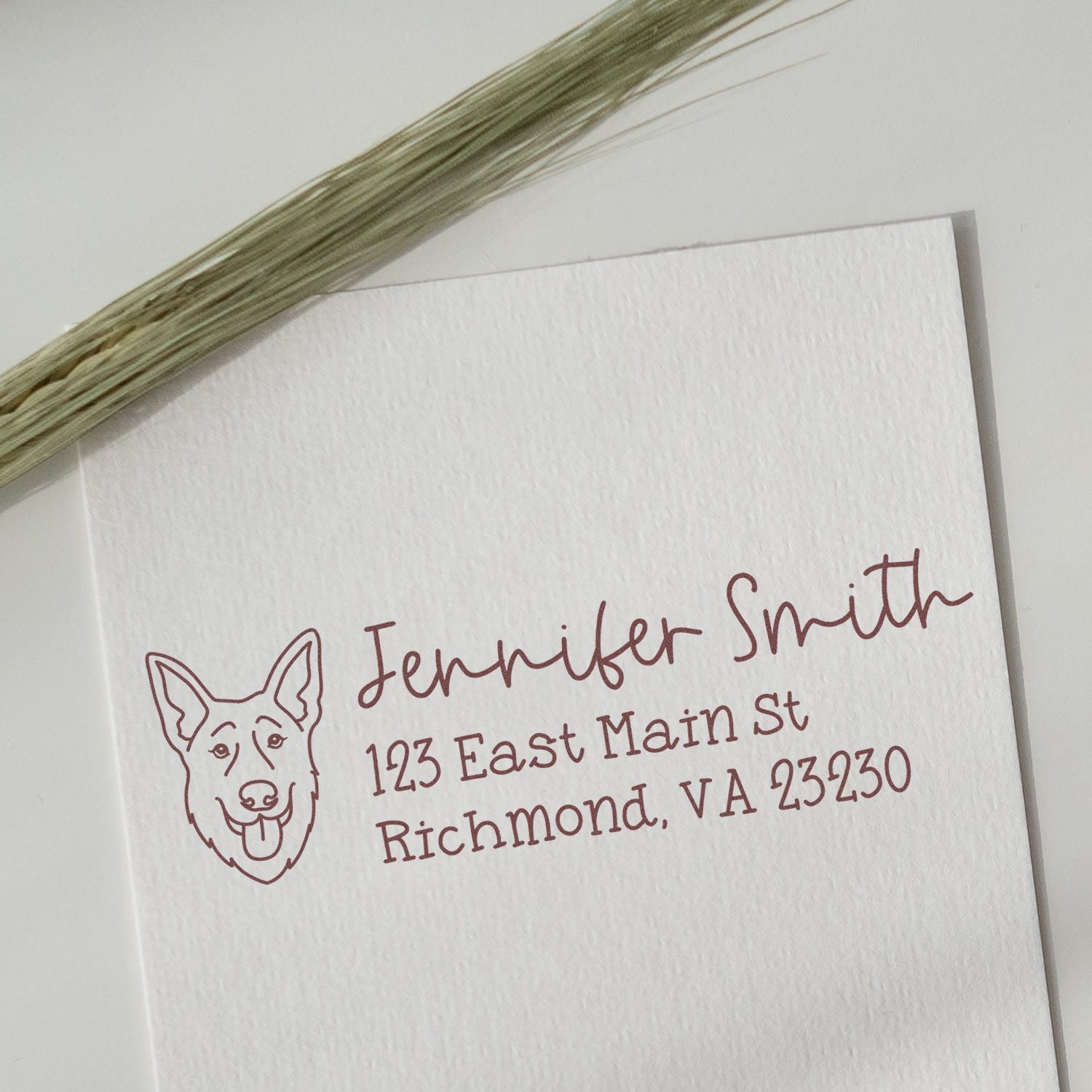 Personalized dog return address rubber stamp impression for Jennifer Smith, Richmond, VA, on white stationery.