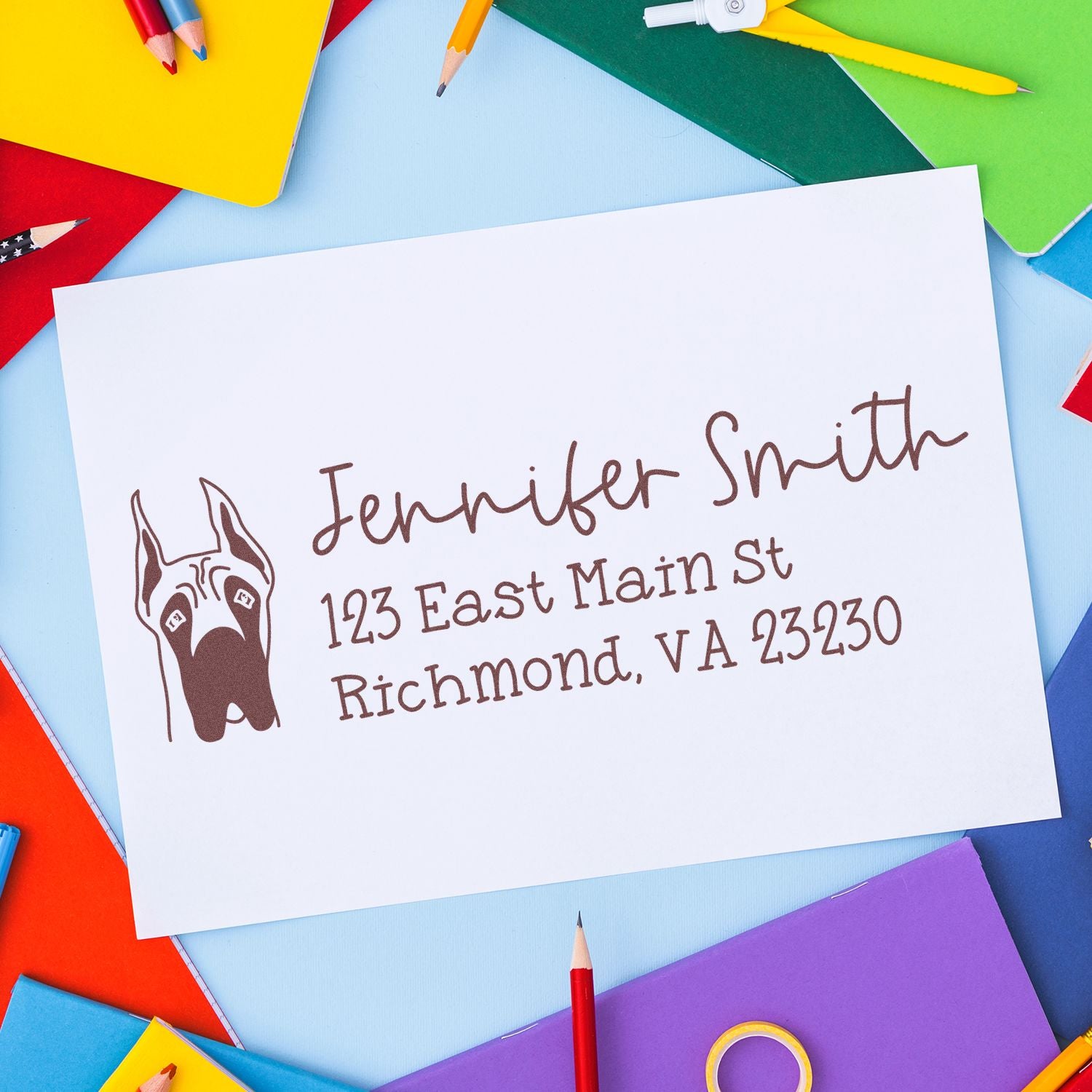 Personalized return address rubber stamp for Jennifer Smith with dog logo on white envelope.