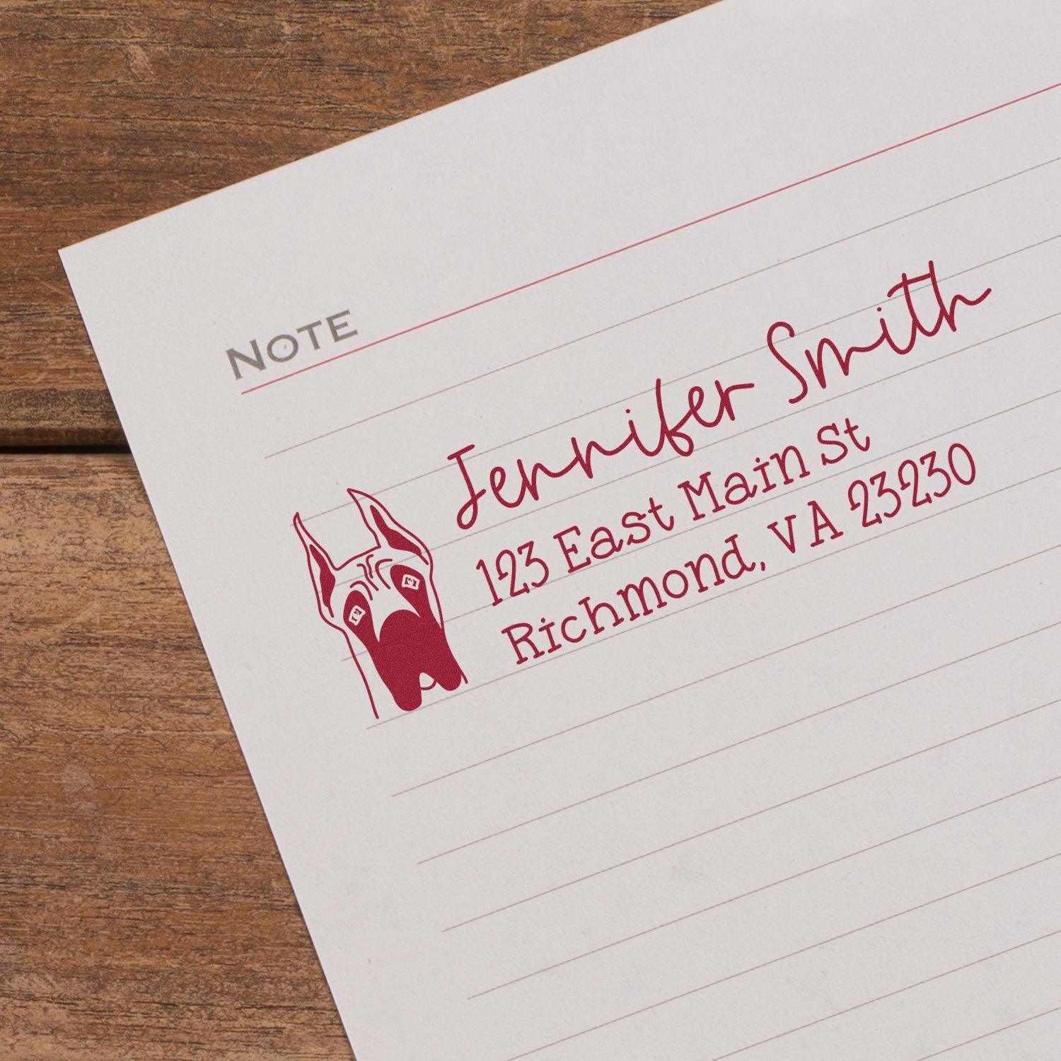 Custom return address rubber stamp with dog logo and Jennifer Smiths Richmond, VA address on notepad.