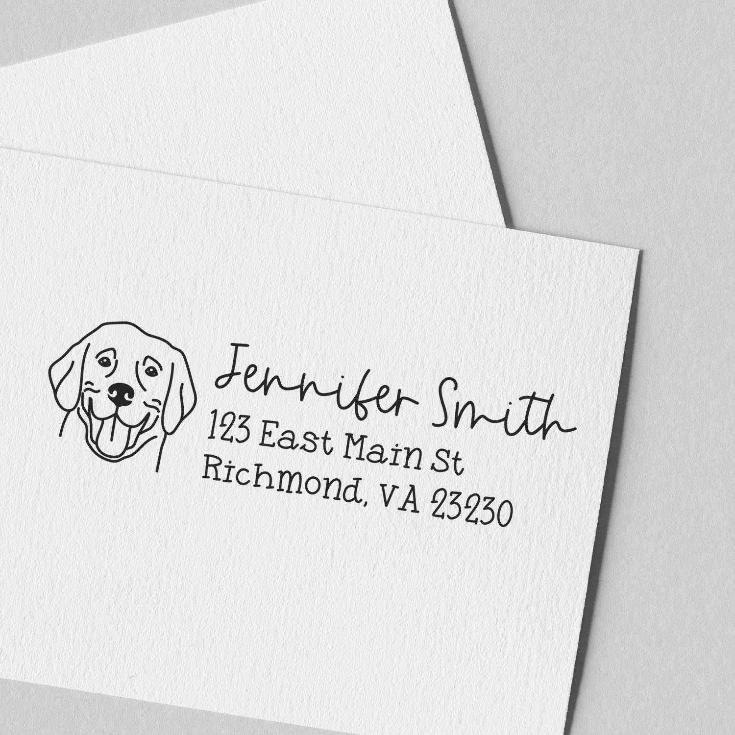Personalized dog return address rubber stamp with pet illustration, name, and mailing address on white envelope.