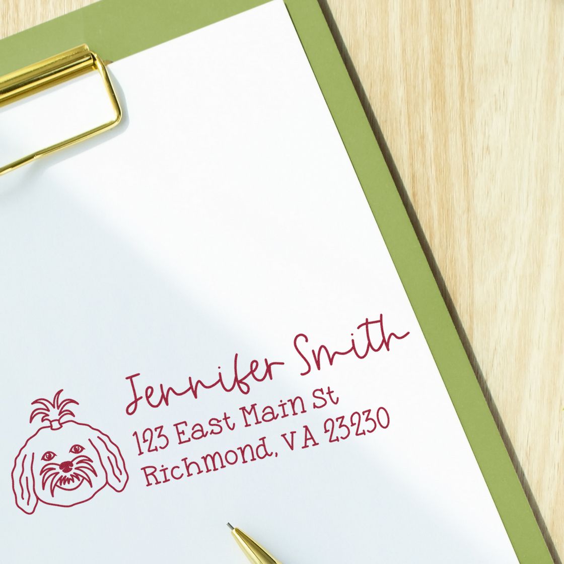 Custom rubber address stamp with dog logo and Jennifer Smith mailing address on paper