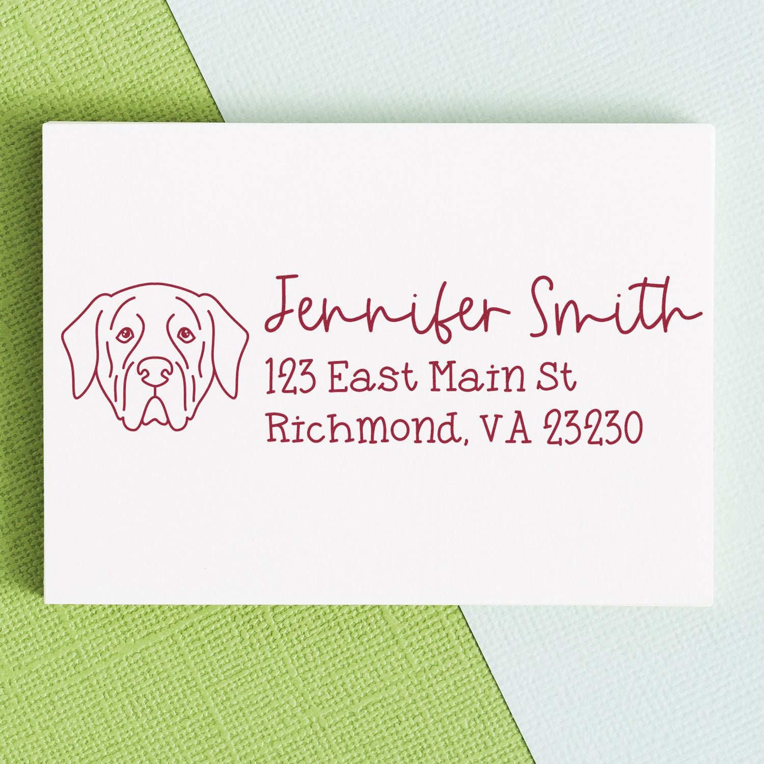 Personalized dog address rubber stamp with name and mailing address in red ink on white card.